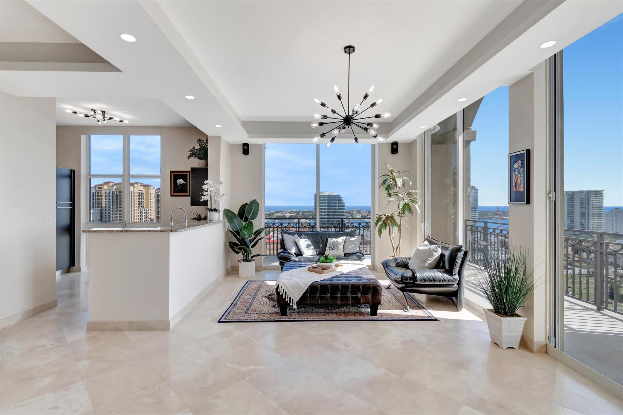 For the first time ever, this exclusive Upper Penthouse retreat is available for resale. Located in vibrant Downtown West Palm Beach, known as ''Wall Street South'' this property is at the center of a booming development scene. This direct East-facing, corner residence offers an unparalleled living experience. Wake up to breathtaking views of the Atlantic Ocean and Intracoastal Waterway, all while being just steps away from the thriving pulse of the city. Perched on the upper penthouse floor, this home offers unmatched privacy and luxury. Three highly coveted parking spaces on the second floor of the garage as well as a large storage unit add significant value to this rare offering. Inside, sophistication meets cutting-edge technology. A state-of-the-art Crestron home automation system
