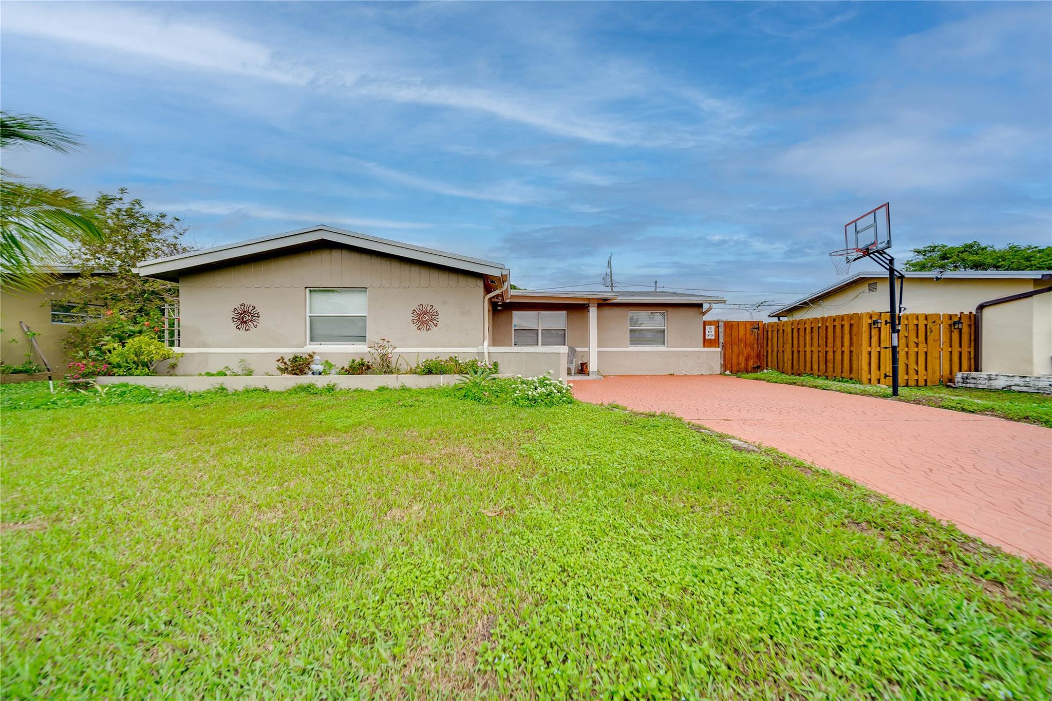 Brilliantly Spacious and Charming Home with Fenced-In Backyard! Tucked away in a sought-after area, this 3BR/2BA, 1,432sqft residence captures attention with a classic stucco exterior, beautiful driveway, and neighborly sidewalks. Impressively maintained, the interior features gleaming tile flooring, soft natural light, luminous sunroom, sizeable living room, and an updated kitchen with stainless-steel appliances, stylish counters, gas range, and wall oven. Thoughtfully fenced-in for ultimate privacy, the backyard oasis boasts a concrete patio, greenspace, mature trees, and a built-in BBQ All three bedrooms are perfectly sized, while the primary bedroom also has an en-suite. Other features: attached garage, laundry area, near schools, shopping, and restaurants, and more! Call for a tour!