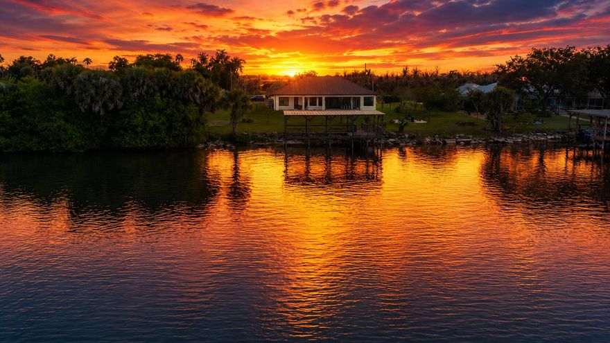 Wake up to tranquil lake views and enjoy a home designed for comfort, privacy and elevated living. This beautifully appointed residence features a rare and highly desirable layout with three spacious bedrooms, each with its own private en suite bath, plus an additional half bath for guests. A stylish den offers the perfect space for a home office, reading room or flexible retreat, while the eat in kitchen creates a warm setting for everyday living and easy gathering. Natural light and serene water views fill the home, creating a peaceful and refined atmosphere throughout. Step outside to your own private waterfront escape with direct lake access and a private boat dock, ideal for boating, fishing or simply enjoying the view. The fully fenced backyard offers privacy and versatility for entertaining or relaxing. Recent upgrades include an AC system less than one year old, storm gutters and a reverse osmosis water system. A spacious two car garage and expansive yard complete this exceptional property. This is more than a home. It is a lifestyle defined by waterfront living, privacy and effortless Florida luxury.