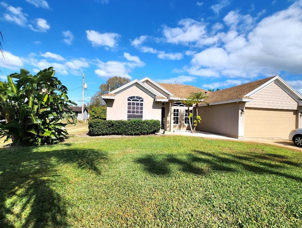 Photo of 721 SW Swan Avenue, Port Saint Lucie, FL 34983 (MLS # R11157026)