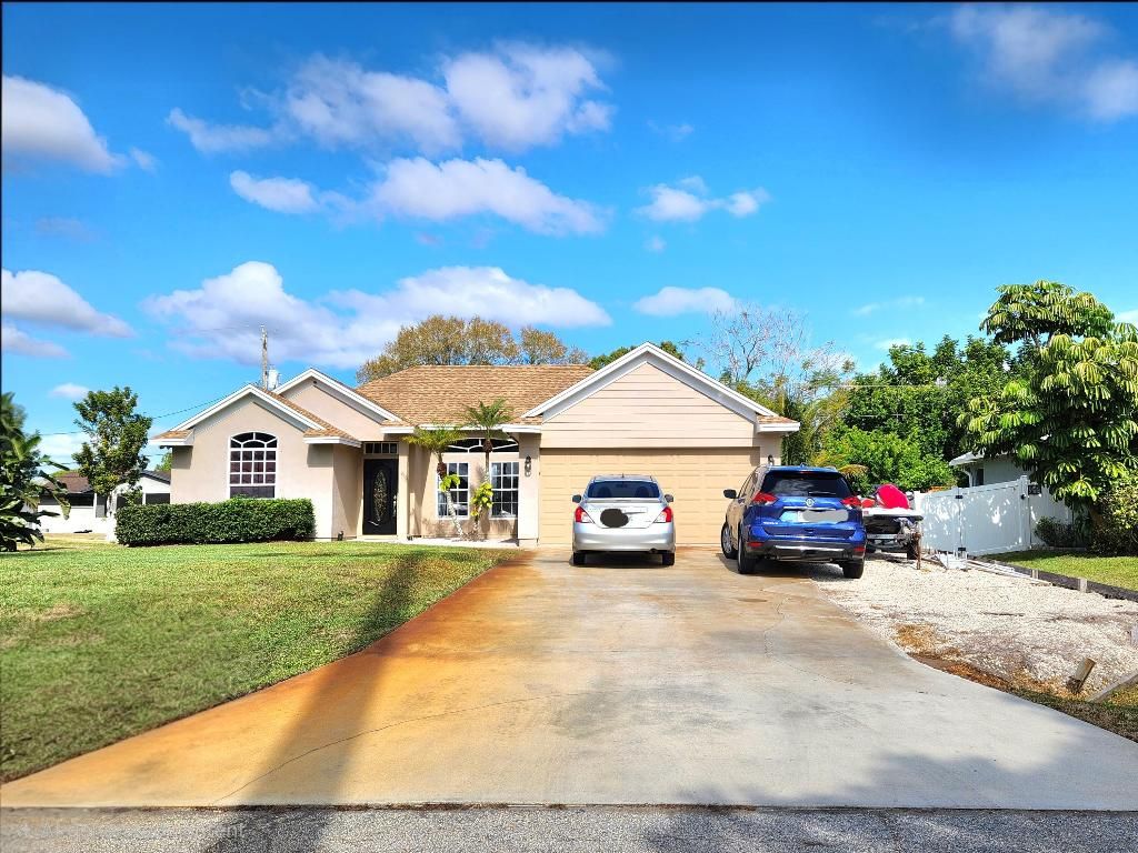 Photo of 721 SW Swan Avenue, Port Saint Lucie, FL 34983 (MLS # R11157026)