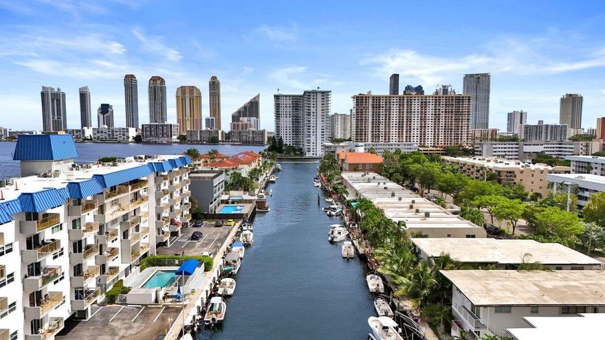 Experience luxury and security in this Eastern Shores waterfront condo, located behind a guarded gate. The 5th floor unit boasts stunning water views from both its large south-facing balcony and north side. Partial impact windows and hurricane shutters through out. High-end travertine finishes throughout, complemented by a fully remodeled kitchen and updated plumbing/electrical system. This 2 bedroom, 2 bathroom layout includes a walk-in master closet for added convenience. With the building surpassing its 40-year certification and being ahead on the 50-year certification, peace of mind is assured. Additionally, seize the opportunity to rent a dock space! This condo offers not just a home but a lifestyle! Deeded dock is only $250/M bring your boat!