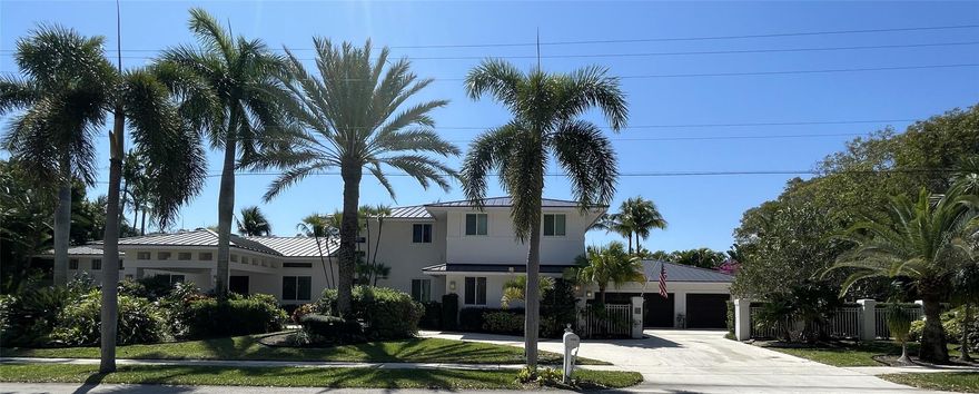 Large house in East Boca Raton, east of federal highway in the prestigious neighborhood of Boca Bay Colony. Great street appeal with a total structural area of 5,893 square feet, recently painted exterior.  Oversized 3 car garage, very deep bays with extra storage, 2 large attics. Brand new metal roof up to the latest wind code. Impact windows are energy efficient glass. Large circular driveway with covered entry portico. Large lap pool 63 feet long with a hot tub. 3 Zone high efficiency air conditioners. Smart phone alarm, pool filler, AC controls and 6 zone watering system. Architect built and owned one owner home. Interior studio apartment. Custom landscaping, very private yard but still a very convenient location. In town close to many restaurants and shopping. Not in a flood zone.