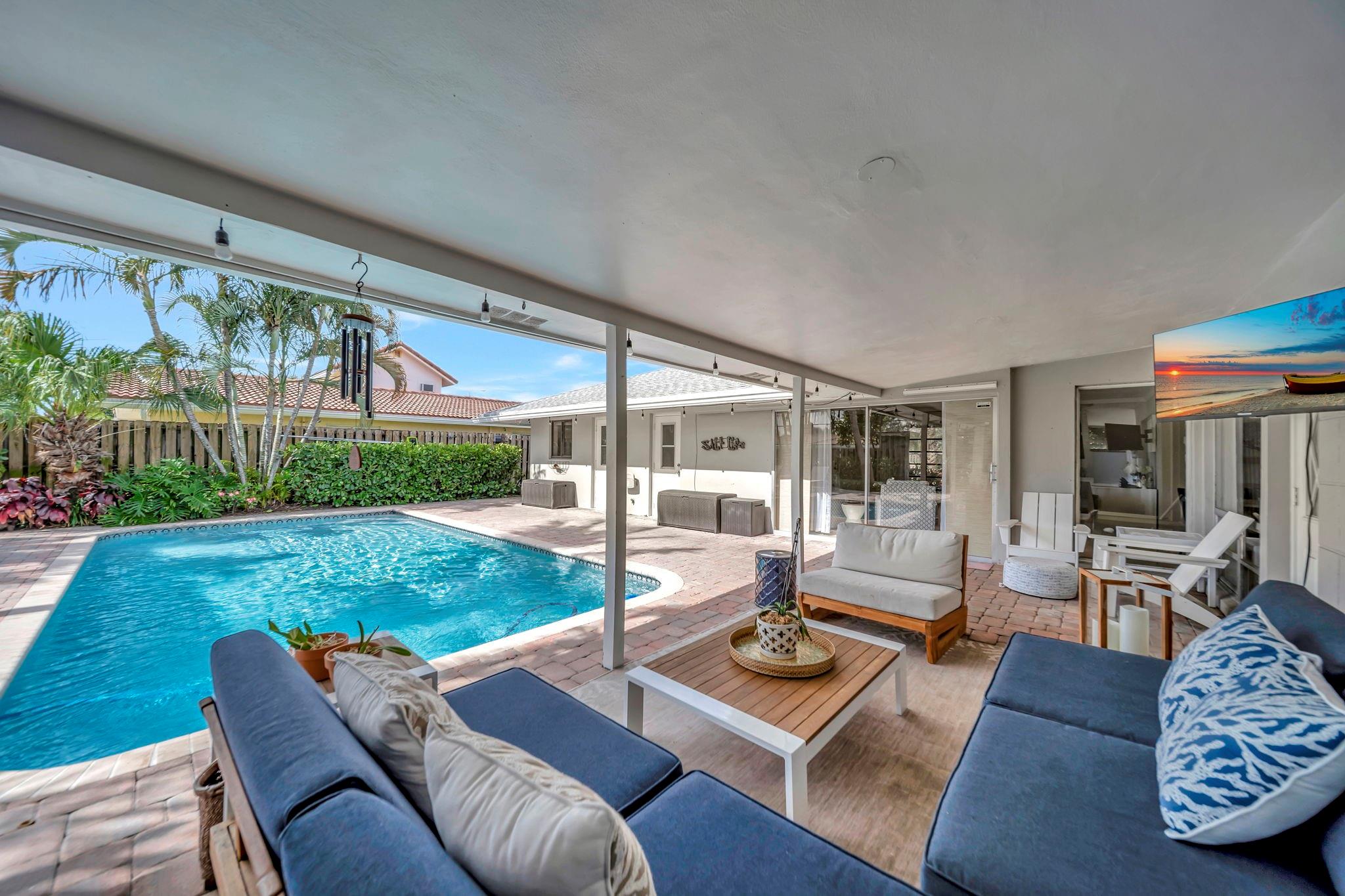 Experience the ultimate South Florida lifestyle in this beautifully 3bed/2bath updated home; ideally located in sought-after Pompano Beach. Inside, the open & airy floor plan is filled w/natural light, creating a warm & welcoming space for both everyday living & entertaining. The kitchen & living areas flow seamlessly together, offering the perfect setting for hosting. The spacious primary suite provides a relaxing retreat, while two add'l bedrooms offer flexibility for guests or a home office. Outside a sparkling pool takes center stage, surrounded by lush green space & ample room for lounging & enjoying the sun. Located just minutes from Pompano’s sandy beaches, waterfront dining, golf & easy highway access, this home offers the perfect balance of relaxation and convenience.