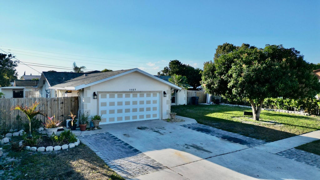 Photo of 1107 Woodcrest Road W, West Palm Beach, FL 33417 (MLS # R11162998)