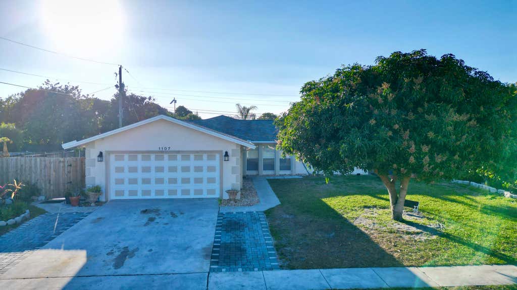 Photo of 1107 Woodcrest Road W, West Palm Beach, FL 33417 (MLS # R11162998)