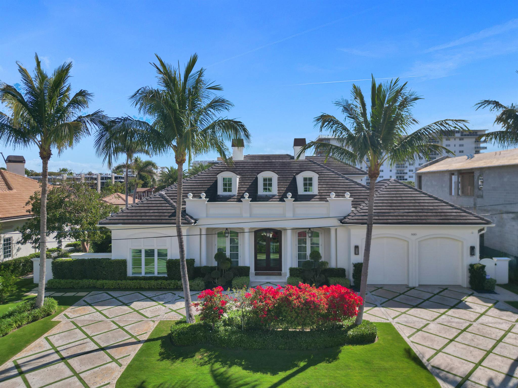 Your Lighthouse Dream Home awaits! This stunning 5 bedroom, 4.5 bathroom waterfront home, completed in 2017, offers the very best of luxury living directly on the Intracoastal and truly leaves nothing to be desired. With breathtaking water views from nearly every room, it features two club rooms with full bars, a first-floor master suite with an office, as well as four luxurious bedrooms and a spacious laundry room. The property boasts 100 feet of Intracoastal frontage, a pool, spa, two boat lifts, and is set on a 14,000 sqft lot, just minutes from the Hillsboro Inlet.The chef's kitchen is a true highlight, with top-of-the-line, stainless steel appliances, sleek European cabinetry, and a spacious island perfect for entertaining.The primary suite is a private retreat with