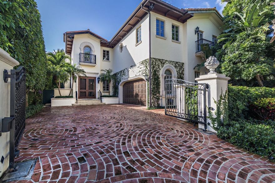 Prime in town location near shopping, fine dining, the beaches and town docks. This elegant 2 story Mediterranean townhome offers gracious entertainment rooms with 12' ceilings, French doors opening onto the pool and loggia offering indoor/outdoor living. Gardens designed by landscape architect Mario Never. Built in 1999 with over 5,200 total square feet. This home offers 3 bedrooms, 3.1 bathrooms, gated entry, 2 fireplaces, elevator, updated kitchen, and full house generator. Beautiful interior finishes and many improvements throughout. Gated privacy and lush gardens, this in-town townhome lives like a house but with the ease of a low maintenance townhouse.