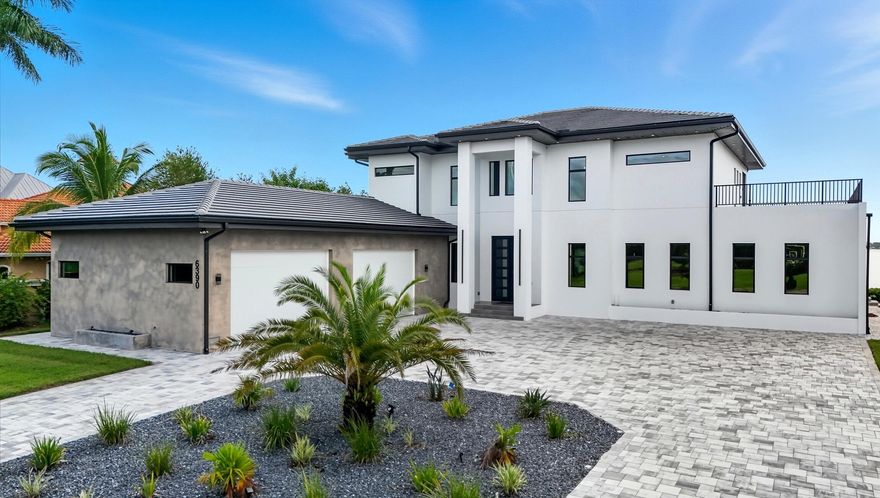 A Rare Waterfront Gem in North Fort Myers!
Tucked away in the exclusive River Club community, this brand-new 2024 estate captures the essence of Southwest Florida living with direct water views, a southeastern exposure, and a design crafted by a renowned German builder known for precision and quality.

This two-story residence welcomes you with a bright, open floor plan that flows seamlessly to the outdoors, where walls of glass frame the river and bring in both spectacular sunrise and glowing sunset views. With an oversized four-car garage -- complete with a built-in car lift for additional parking and collector storage -- this home blends everyday functionality with luxurious details throughout. This home encompasses a total area of 8,582 sq. ft., complemented by a spacious 4-car garage, inviting entry, covered lanai, and expansive balcony, as measured by building plans. Comfort is ensured year-round with a three-zone air-conditioning system (3 AC units), allowing efficient and customized climate control throughout the residence.

Set on an oversized lot, the property offers exceptional outdoor living. A custom infinity-edge pool and spa with sun shelf and spillovers create a resort-like ambiance, all enclosed for year-round comfort. Two expansive roof terraces provide the perfect vantage point for cocktails at sunset or morning coffee overlooking the water.

For boating enthusiasts, the home is fully equipped with a 14,000-lb boat lift capable of handling vessels up to 30 feet and a 7,000-lb jet ski platform, making waterfront adventures effortless. Electric storm shutters add an additional layer of protection and convenience, and importantly, the property remained completely dry during recent storms -- offering peace of mind along with its beauty.

Every aspect of this residence reflects thoughtful design, from its open, light-filled interiors to its elevated outdoor spaces. With craftsmanship you can feel and a lifestyle you'll cherish, 6390 River Club Court is more than a home -- it's a true statement in modern Florida waterfront living.