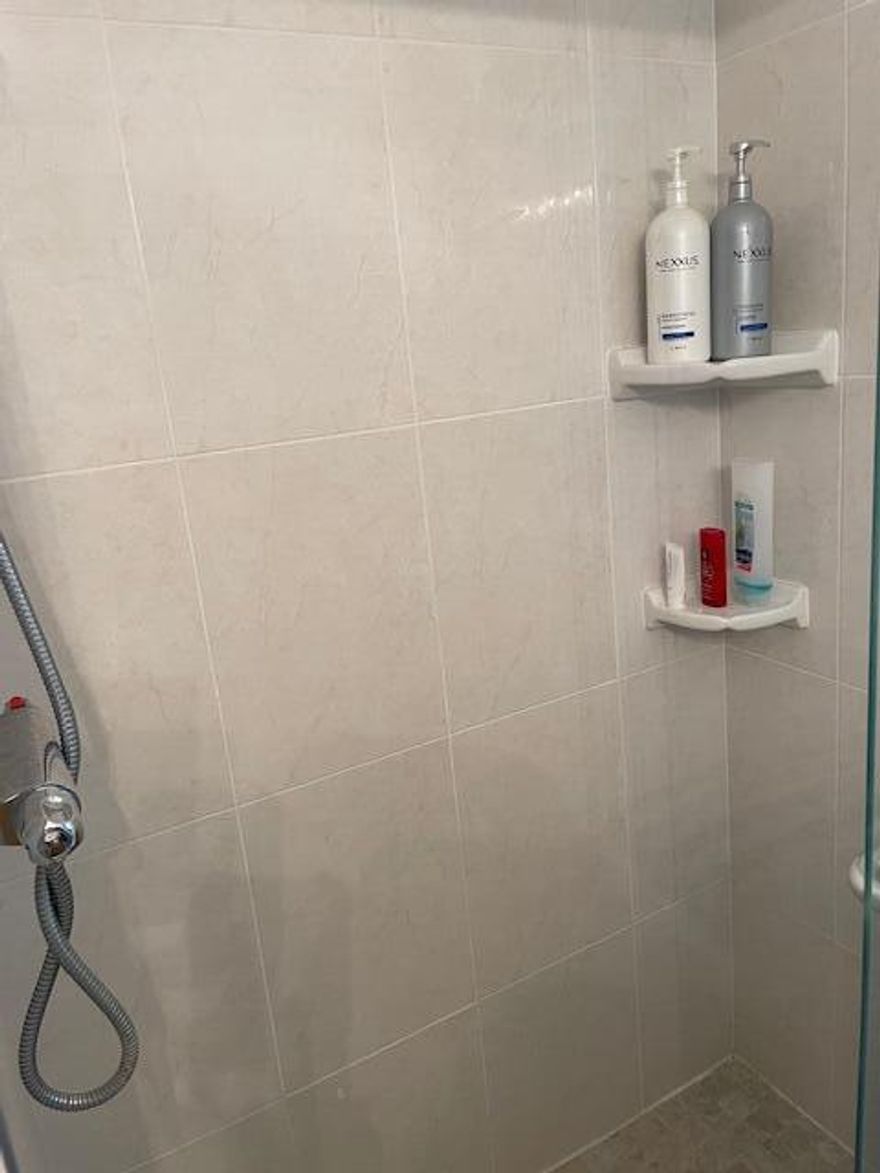 This beautifully renovated corner villa offers a perfect blend of comfort and style, set against a serene lakefront backdrop. The home features elegant porcelain tile flooring throughout, impact-resistant glass windows, and a fully enclosed, air-conditioned patio with glass panels and window treatments—ideal for year-round enjoyment. The kitchen is thoughtfully updated with stainless steel appliances, rich wood cabinetry, and a convenient pantry. Enjoy breathtaking lake views that create a tranquil, retreat-like atmosphere right at home. Located in the gated community of Golden Lakes Village, residents have access to a wide range of amenities.