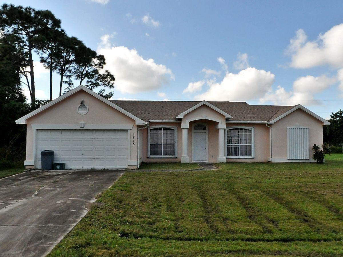 This 3-bed, 2-bath in Port St. Lucie offers over 1,500 sq. ft. of potential. Located at 1618 SE Ridgewood Ave, it sits in a quiet, established neighborhood with no HOA and easy access to US-1, shops, dining, and beaches. The home features a split floor plan, attached garage, and a spacious backyard. Needs full interior renovation, It has a brand new roof. Sold as-is. Don't miss this opportunity!