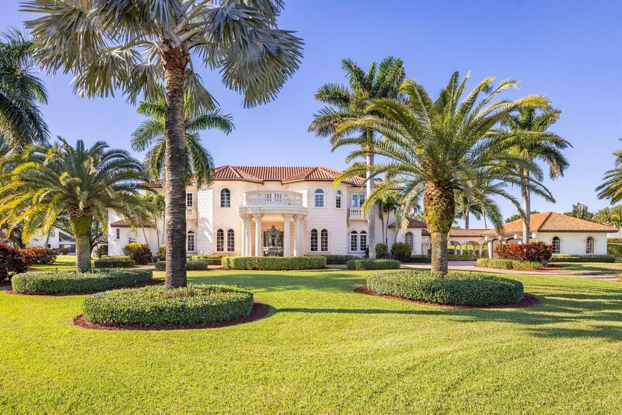 This meticulously crafted transitional-styled residence has been reimagined and is prominently positioned on a secluded waterfront lot exceeding 1 acre. The entrance is graced by an elegant circular drive, featuring an extended portico-covered entry and a majestic 10' European fountain-feature which guides one to 7,850 sq. ft of luxurious interior living space. The first floor unfolds with a spectacular sunken living room with reflective pool views and soaring ceiling opposite a large, elegant dining room. The private office is just outside the opulent primary suite, offering direct pool access, double walk-in closets, and a lavish master bath boasting a double vanity, stand-alone Roman tub, and a separate shower. A first-floor private en-suite guest room.. SEE MORE