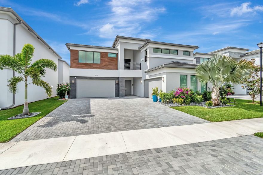 Welcome home to luxury resort living at 8564 Ganton Dr in the prestigious Lotus Palm. This exquisite Maldives model boasts 6 spacious bedrooms, 5 ensuite baths, 1 cabana bath and 2 half baths, a media room, and sophisticated upgrades including a premium custom kitchen with Thermador appliances, expansive white oak flooring,  smart home automation, and designer fixtures. Situated on a premium southern-exposure lake lot, this home offers serene water views and plans for a private pool. Lotus Palm's amenities include a stunning clubhouse with pools, fitness center, restaurant, sports courts, 5 pickleball courts, 6 tennis courts, kids center  and a full calendar of social events, all within a secure community featuring a 24-hour manned gate. Live every day like a vacation!