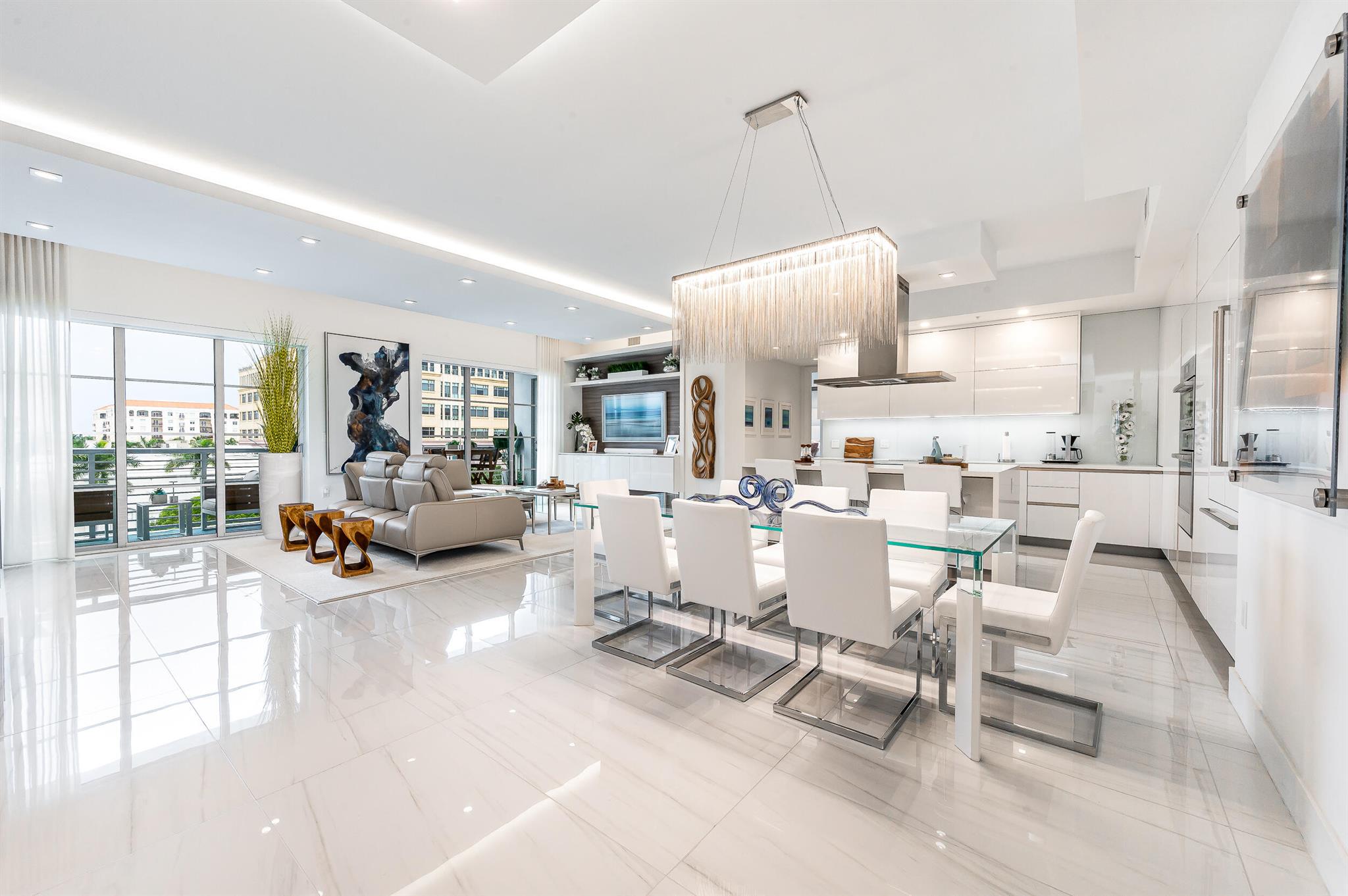 Welcome to the epitome of luxury living in the heart of downtown Boca Raton! This exquisite 3-bedroom 3-bath apartment offers a spacious open concept floor plan with 10-foot ceilings. Designed by Interiors by Steven G this unit is a gem. Features abound including chef's kitchen with quartz countertops, Italian cabinetry, and Bosch appliances. Living room has a custom built-in bar with wine refrigerator and beverage refrigerator. Master suite is complete with large his and hers walk in closets. A home office area is expertly integrated into the apartment's layout and design featuring dual workspaces, storage cabinets, and shelving units. Porcelain tile floors span throughout the apartment. Two parking spaces come complete with a dedicated electric vehicle charger.