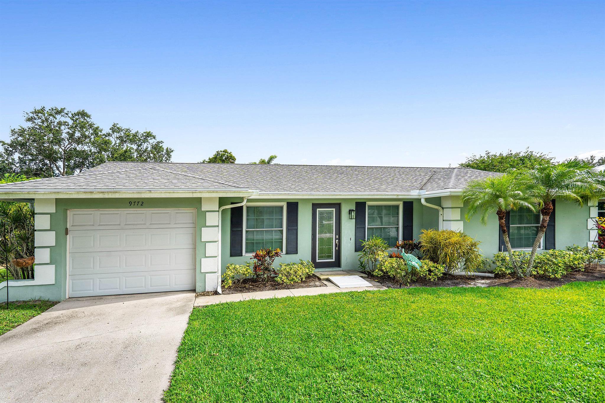 Fabulous Little Club. Best deal in Northern PBC Golf, tennis, pool, shuffleboard, clubhouse all for $182/ month.This charming 2 BR home has impact windows, large lot, new kitchen,glass enclosed Florida Room with seperate AC. large laundry and storage room, 1 car garage. Freshly painted, luxury vinyl floors, and more. Open concept living makes the home light and bright. The new kitchen features pull-out drawers, quartz countertops,custom island, stainless appliances, custom cabinets with pass through window to the Florida Room making entertaining easy. The room overlooks a large lawn. &pavered patio for indoor/outdoor entertainment. This charming home for 55+ residents allows owners to lock and leave for the summer if they so desire. Easy to see - vacant.