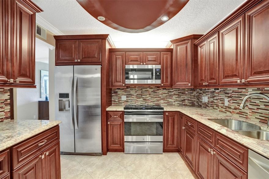 BEAUTIFULLY REMODELED HUGE 2/2 CORNER UNIT. RARE L-MODEL FEATURES LARGE EAT IN KITCHEN WITH PANTRY. OVERLOOKING GOLF COURSE WITH ENCLOSED PATIO. REMODELED KITCHEN WITH STONE COUNTER TOPS AND UPGRADED APPLIANCES. ENJOY THE MUTI-MILLION DOLLAR CLUBHOUSE WITH FITNESS CENTER, HEATED POOL, BILLIARD AND CARD ROOM, THEATER AND SOCIAL CLUBS. ABUNDANCE OF CLOSET SPACE. TAKE ADVANTAGE OF THE  FREE SHUTTLE SERVICE. THIS UNIT WILL NOT DISAPPOINT.