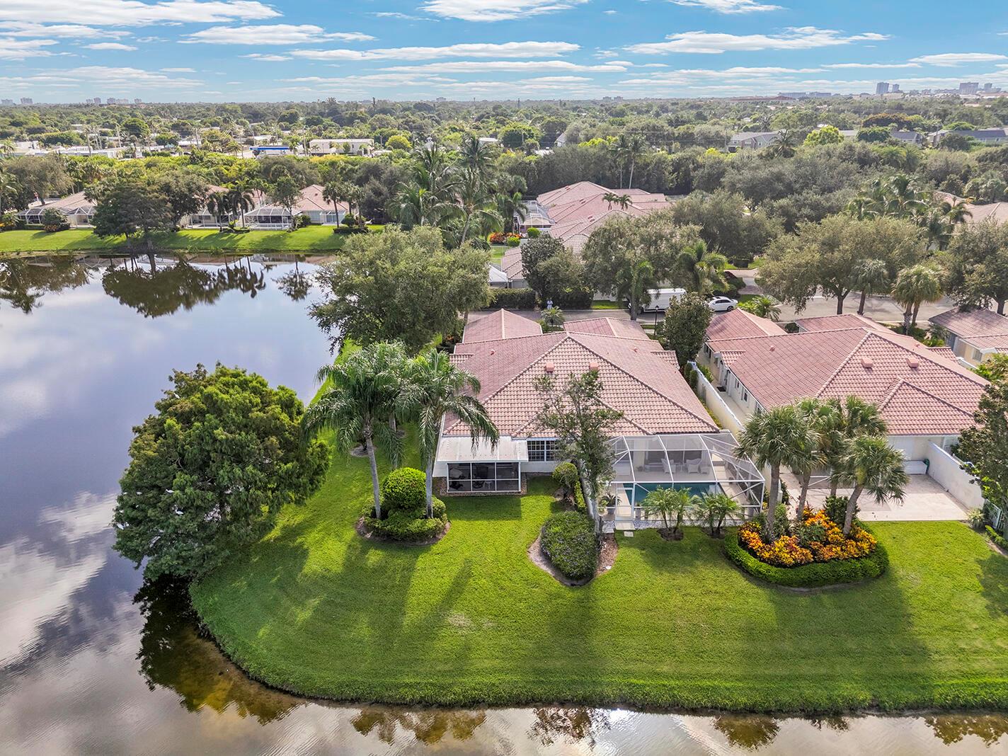 Rarely available corner villa in The Isles, perfectly positioned on the community's largest lake with stunning water views on two sides. This gem offers a spacious and flexible split-bedroom floor plan, ideal for both everyday living and entertaining. The beautifully updated kitchen features brand-new stainless steel appliances, and the home has been lovingly maintained and is truly move-in ready. Enjoy serene lakefront living from your screened patio with fire pit, the perfect spot for relaxing sunsets or hosting guests. The Isles offers a resort-style lifestyle with amenities including a fitness center, heated pool, tennis, pickleball, and bocce ball. Conveniently located close to shopping, dining, and more. This unique corner residence