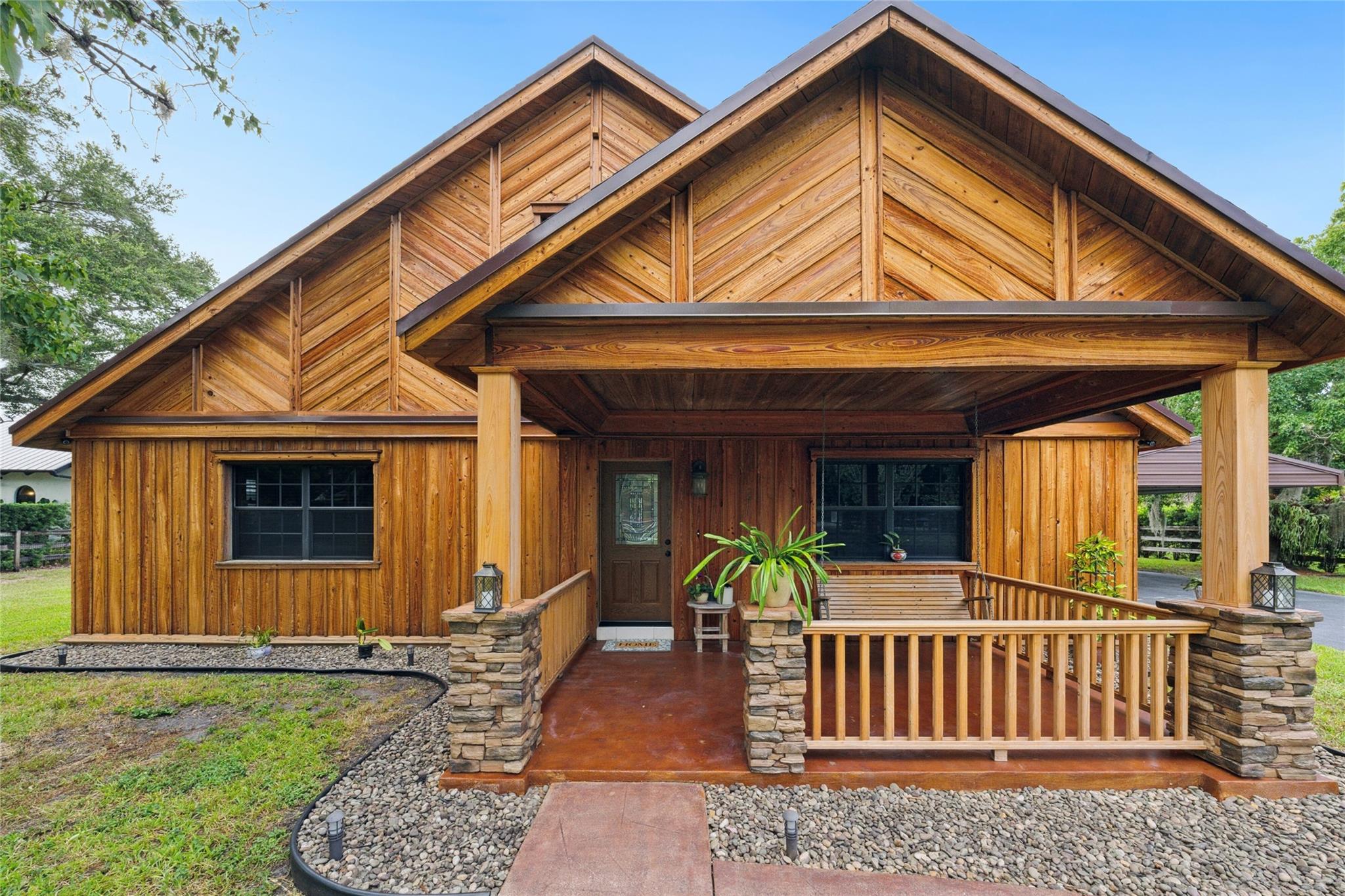 PRIVATE SANCTUARY, ELECTRIC GATED LARGELY REMODELED NORTH CAROLINA STYLE HOME WITH COZY CABIN FEEL! CBS CONSTRUCTION & 2ND STORY FRAME SIDED WITH THICK CYPRESS! MAPLE TREES TURN COLOR IN THE FALL! A REAL FRONT PORCH! NEW ROOF! NEW STUNNING QUARTZ KITCHEN, SMART FRIDGE, LIGHTED CABINETS! 5 BURNER STOVE, STAINLESS HOOD VENTS OUT! TANKLESS HOT WTR HTR! LARGE 24X48 TILE FLOORS! MAIN BR IS DOWN, BONUS ROOM COULD BE OFFICE/CRAFT/GYM ETC. UPSTAIRS IS HUGE-USED AS ONE GIANT BEDROOM, WALK IN CLOSET & FULL BATH, EASY TO DIVIDE INTO 2 LARGE BEDROOMS. IMPACT WINDOWS & SLIDER UPSTAIRS, EASY TO CREATE A WALK-OUT DECK. SPACIOUS 1BR/1BA GUEST HOUSE! DETACHED 2 CAR GARAGE, EXCELLENT WORKSHOP OUT BACK! HORSES WELCOME! LARGE CONCRETE PAD FOR MOTORHOME. DEAD END STREET IN THE HEART OF DAVIE'S HORSE COUNTRY!