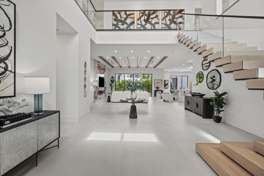 Introducing an extraordinary Zabci Custom Home, poised to grace the highly coveted Mizner Park section of Boca Villas. This remarkable residence embodies the pinnacle of luxury living in one of Palm Beach County's most prestigious neighborhoods, where world-class golf, elite tennis, gourmet dining, high-end shopping, and breathtaking ocean beaches are merely moments from your door.This unparalleled home features five en-suite bedrooms, and 6 full and 1/2 baths, complemented by an expansive loft and a full-sized home office, exquisitely designed to blend comfort with versatility. A private elevator and a state-of-the-art 32 KW generator elevate convenience, while strategically placed laundry rooms on both levels streamline daily living. With pre-installed wiring, this home is primed for
