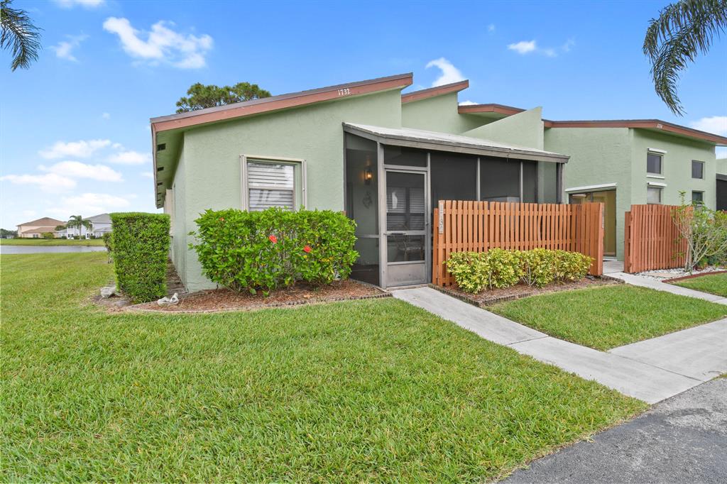 Super cute and clean 2 bedroom, 2 Bath end unit with a screened in front porch with a lake on the rear and a New Roof in 2021. As you walk in, you will see the large living area and laminate floors throughout the living areas, tile in the Kitchen and Bedrooms and newly installed Carpet in the Bedrooms. Kitchen was updated with newer Kitchen cabinets and corian counter tops. Large Master Bedroom and Bathroom has a stand-up shower with a built-in makeup area. 2nd Bedroom has a murphy bed that will be left in that room and the Dining Room table and chairs that will be left in the home. All windows have accordion hurricane shutters that are easy to close.
