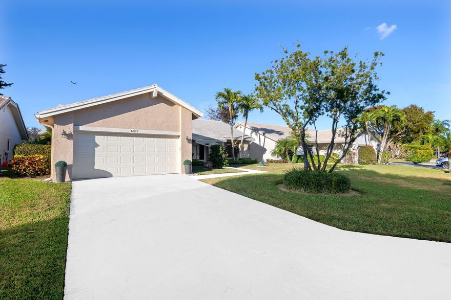 Imagine sipping your morning coffee on your enclosed patio, enjoying water and garden views, and the calm of a close-knit, 55+ Boca del Mar neighborhood. Evenings could be spent relaxing in the community pool or connecting with friends at the clubhouse, all just steps from your door.  This lovingly maintained 3-bedroom, 2-bath home with XL driveway and 2 car garage at 6053 Petaluma Drive offers a bright, open layout with volume ceilings and tile floors, making it easy to entertain or unwind. The spacious master suite features two closets—including a walk-in—and a marble-accented bath with a private wet room for ultimate comfort. With a flexible dining room, 2-car garage, and LOW HOA every day here blends ease, style, and the relaxed lifestyle you've been looking for.