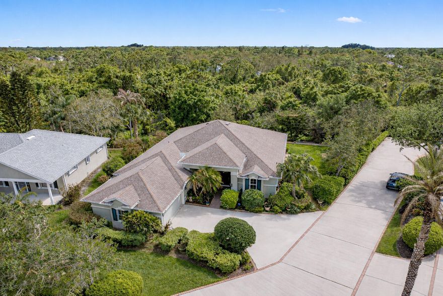 First time available--rare opportunity. Original owners selling.  Spacious 3/2 with den, split BR plan with amazing 35X9 glassed in porch overlooking private, back terraced yard with tiered patios.  In total, nearly 3000 sq ft of home.   Larger 22.4X20.4 garage, separate laundry room.   Volume ceilings, crown moldings, newer 2022 roof, tile, wood and laminate flooring. Complete set of accordion shutters plus automatic roll down shutters in front.  Lawn sprinkler on well.  Botanical gardens and privacy hedges enhance the grounds.  No age restrictions in this gated golf community.  Great clubhouse with fitness room, large pool and activities.   Owner occupied.