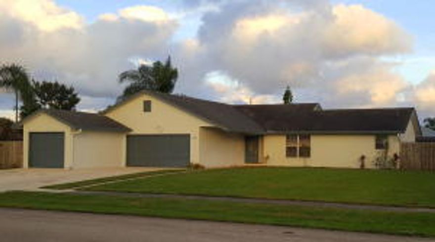 Spacious and well-maintained home in a wonderful neighborhood has everything you’ve been looking for! This MOVE-IN CONDITION split-plan home features 3 bedrooms, 2 full baths, and a rare oversized 4 car garage on a fully fenced, large corner lot. Additional features also include beautifully updated kitchen and baths, tile & laminate floors throughout, lots of storage, screen enclosed 
covered patio to enjoy outdoor relaxing and entertaining, newer Hot Water Heater & updated A/C, storm shutters, large 13 x 9 storage shed and a huge ventilated garage space, perfect for the car enthusiast or hobbyist. Walk to beautiful waterfront parks, playground, basketball, sand volleyball & even a dog park! Convenient location close to everything. Nothing to do but unpack!