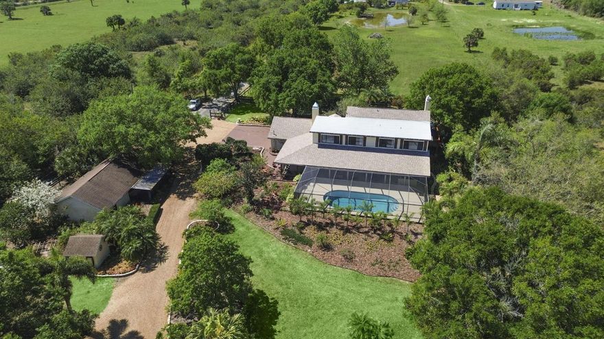Make your mooove to this one-of-a-kind 7.65-acre ranch estate with a screened-in POOL, NEWER 2022 ROOF, a fully equipped GUEST HOUSE, 6-horse stable, stockable pond, 2024 and 2020 AC units, storage shed, TWO wells, a water softener system and MORE! This size property is perfect for your fruit trees, cows, goats, treehouse, place to park your RV, boat, etc. The MAIN house has 4BD 3BA, an updated kitchen and two cozy fireplaces and NEW 2025 flooring. The master suite overlooks the property and has a private balcony to enjoy your coffee and a spa-like master bath. There are plenty of windows throughout the house to open for airflow in cooler weather and enjoy natural light. The built-in jacuzzi and oversized screened-in pool (30x14) area overlook the pond perfect for enjoying your morning coffee with a view. The pool was resurfaced, repainted and had a new filter installed all in 2024.Whether you're hosting gatherings or simply enjoying a quiet evening under the stars, this outdoor oasis is designed for relaxation and entertainment.

The stockable pond is the perfect setting for fishing, having a picnic or simply enjoying the peaceful water views from a swing you can set up by the large tree. Equestrian and hobby enthusiasts will love the 6-stall barn with a tack room and workshop, providing ample space for horses, livestock, or extra storage.

For those seeking multigenerational living, the estate also boasts a full mother-in-law suite, an excellent option for guests or an office space. It's fully equipped with its own kitchen, W/D, full bathroom, living room and screened-in front porch.

This property truly has it all: space, country-side living, endless possibilities and is STILL located within about 30 min from the BEACH, golfing, shopping, dining and retail (St. Lucie West, Tradition). Whether you're looking for a private retreat, an equestrian haven, this ranch-style paradise is ready to welcome you home!