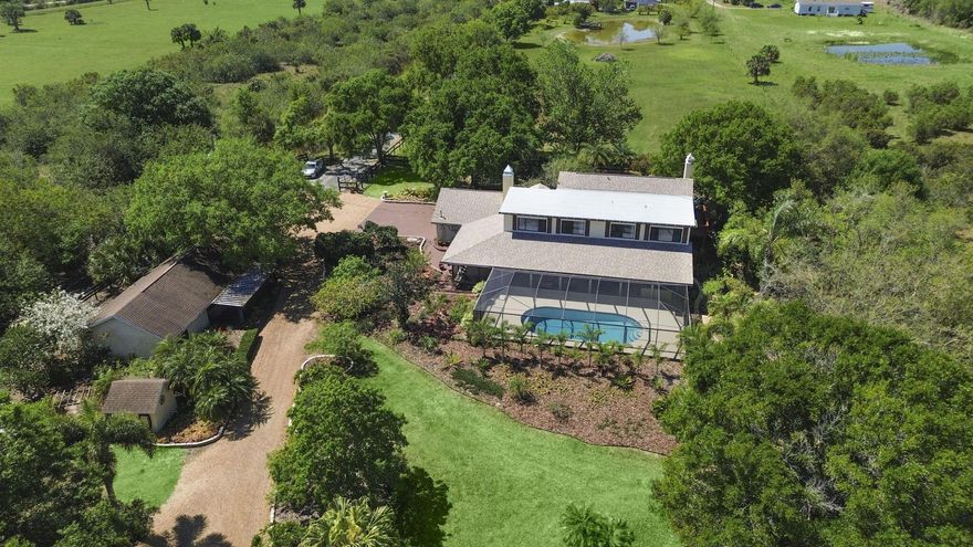 Make your mooove to this one-of-a-kind 7.65-acre ranch estate with a screened-in POOL, NEWER 2022 ROOF, a fully equipped GUEST HOUSE, 6-horse stable, stockable pond, 2024 and 2020 AC units, storage shed, TWO wells, a water softener system and MORE! This size property is perfect for your fruit trees, cows, goats, treehouse, place to park your RV, boat, etc. The MAIN house has 4BD 3BA, an updated kitchen and two cozy fireplaces and NEW 2025 flooring. The master suite overlooks the property and has a private balcony to enjoy your coffee and a spa-like master bath. There are plenty of windows throughout the house to open for airflow in cooler weather and enjoy natural light. The built-in jacuzzi and oversized screened-in pool (30x14) area overlook the pond perfect for enjoying