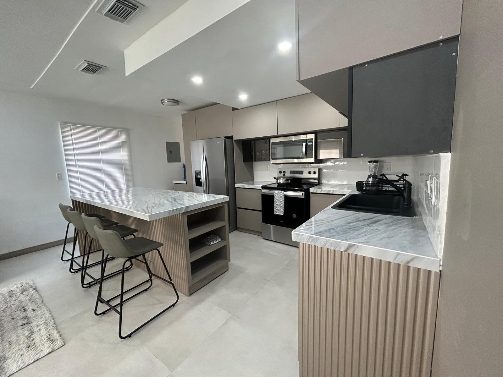 Completely Renovated Single-Family – Designer Kitchen – Central Location!
Step into your cozy, ready-to-move-in dream home! This beautifully renovated single-family residence comes with all new furniture, featuring a bright open layout and a modern designer kitchen with Italian countertops and a stunning island — perfect for entertaining friends. The spacious living area includes a sectional sofa that converts into a queen bed, two elegant bedrooms with queen beds, and a stylish updated bathroom. Includes laundry in the home, plenty of parking, and a prime central location just blocks from Broward General Hospital, the airport, and Port Everglades.