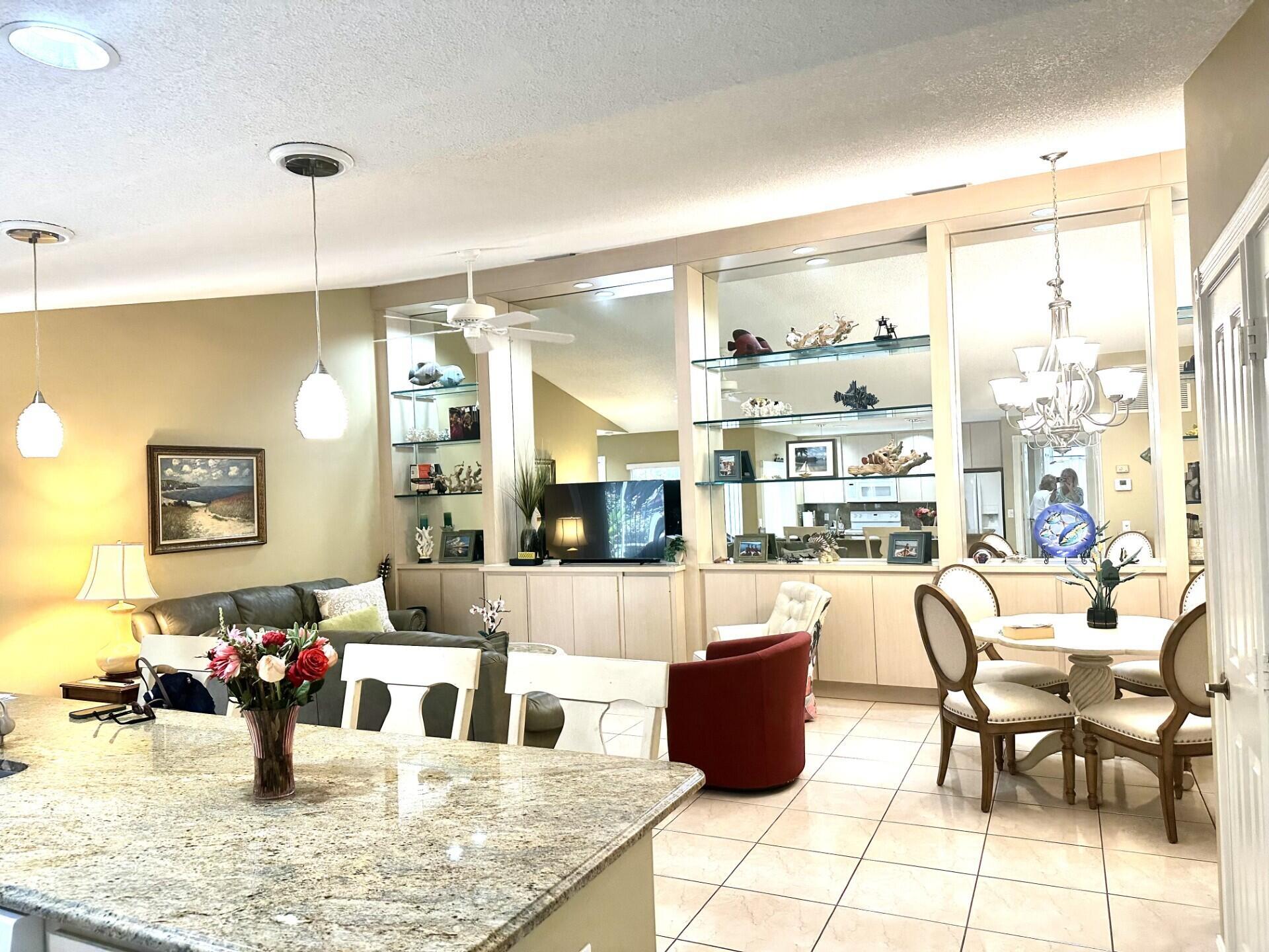 Great opportunity in this centrally located townhome with oversized screened patio and garden views. Furnished beautifully with everything you need this home has an open concept with volume ceilings encompassing a spacious living room with built-in cabinetry, adjacent dining area, all open to the kitchen with large center island. The bedrooms are split, each with a wall to wall closet, full bath and patio access. There is a great additional storage area on the patio. And...the patio is large enough for a dining area and ourdoor living room. Around the corner is a wonderful community pool with restrooms. Sun Terrace is centrally located close to an abundance of shopping and dining.