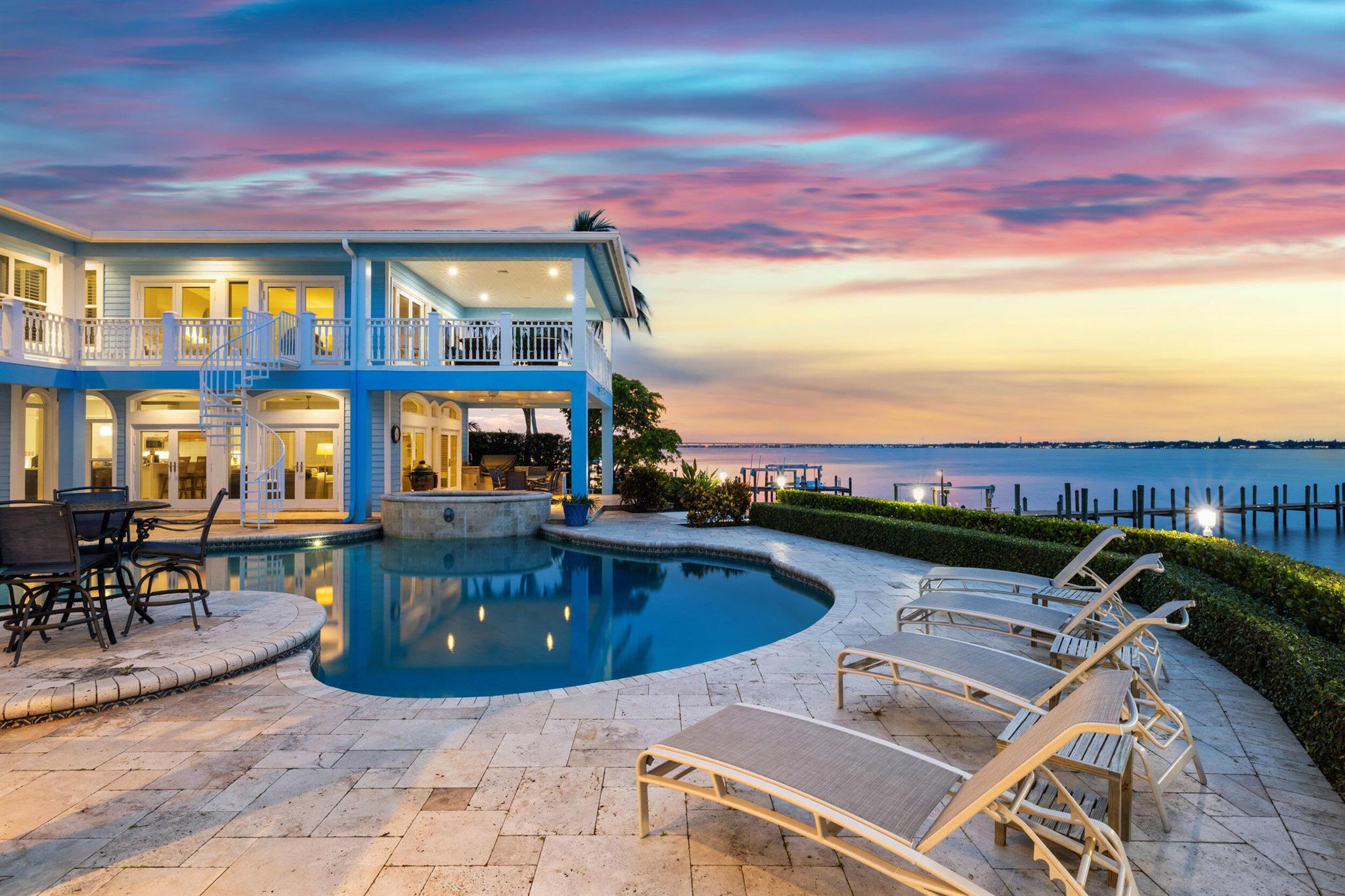 Located on coveted Riverside Dr near downtown Stuart, this waterfront estate blends timeless design with modern luxury. With 5 beds, 5.5 baths, and over 6,700 total sq/ft, it offers 100+ feet of wide waterfront views, a seawall, and a renovated dock with dual lifts (24k & 13k lbs). A private in-law suite supports multigenerational living. Resort-style outdoor living features a oversized heated pool/spa, covered patio, outdoor shower, built-in gas grill, and oversized balconies overlooking the St. Lucie River.