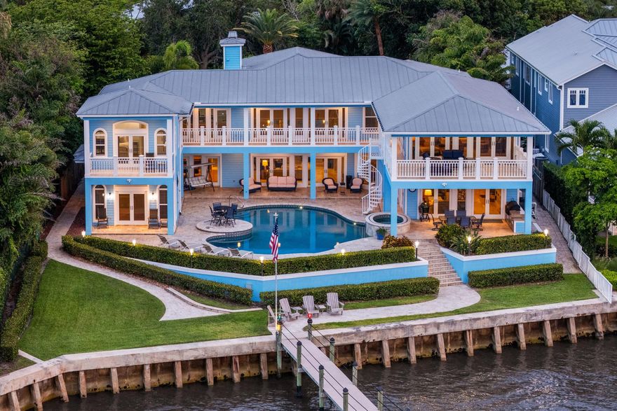 Located on coveted Riverside Dr near downtown Stuart, this waterfront estate blends timeless design with modern luxury. With 5 beds, 5.5 baths, and over 6,700 total sq/ft, it offers 115+ feet of wide waterfront views, a seawall, and a renovated dock with dual lifts (24k & 13k lbs). A private in-law suite supports multigenerational living. Resort-style outdoor living features a oversized heated pool/spa, covered patio, outdoor shower, built-in gas grill, and oversized balconies overlooking the St. Lucie River.