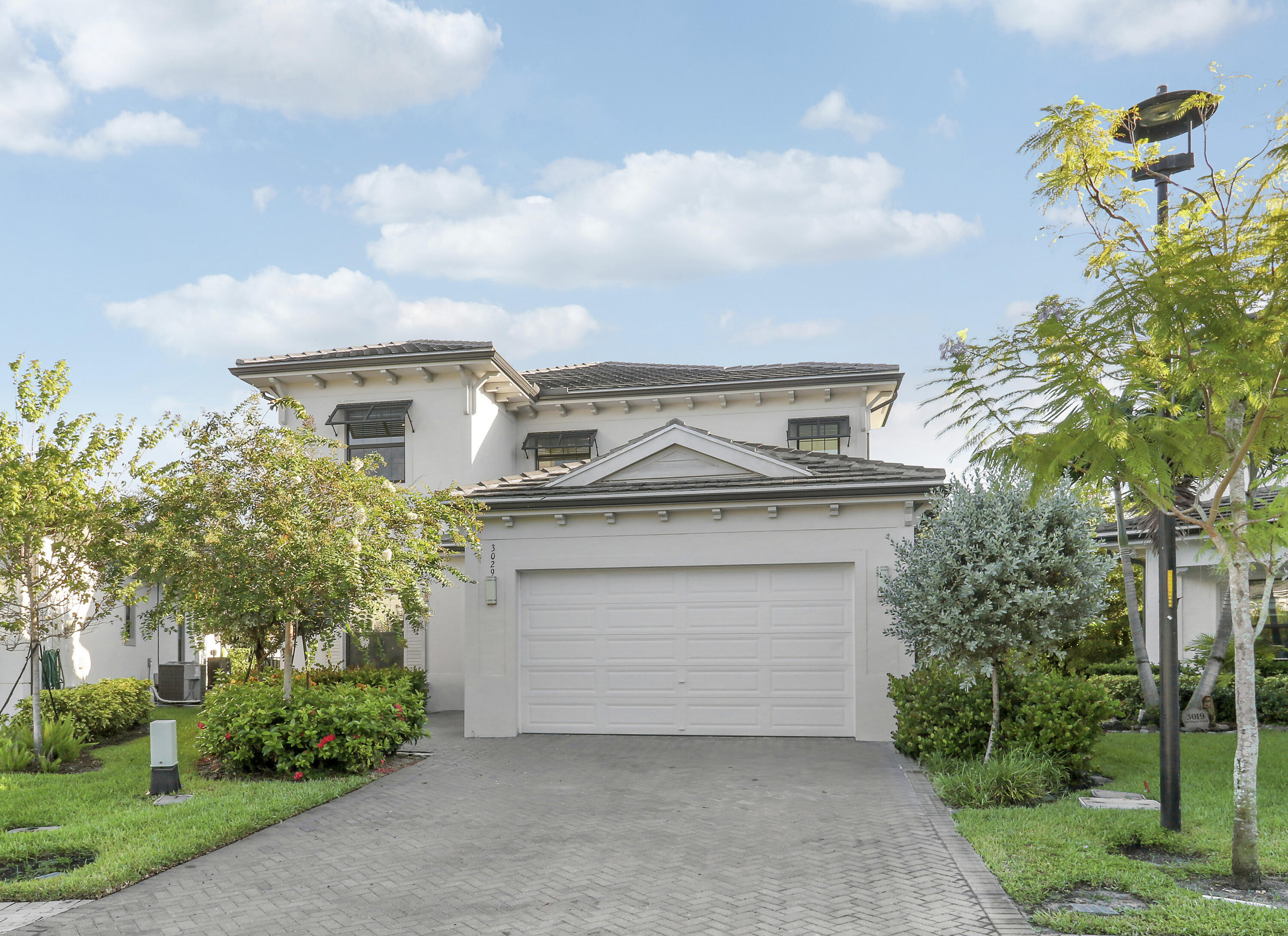 Welcome to the gated community of Banyan Cay, where luxury living meets modern design. This stunning Grenada model built in 2021 offers 3 bedrooms and 3.5 bathrooms plus a 2-car garage, complemented by exceptional upgrades and thoughtful details throughout. An elegant den features custom built-in shelves with a library ladder and a cozy seating area, while the chef's kitchen boasts floor-to-ceiling cabinetry, quartz countertops, and upgraded appliances.The main level includes a bedroom with an attached full bathroom, perfect for guests, a large storage closet under the stairs, and open living spaces that feature motorized shades. Sliding doors in the living room and kitchen open seamlessly to the covered patio, creating inviting indoor/outdoor living during the cooler months.