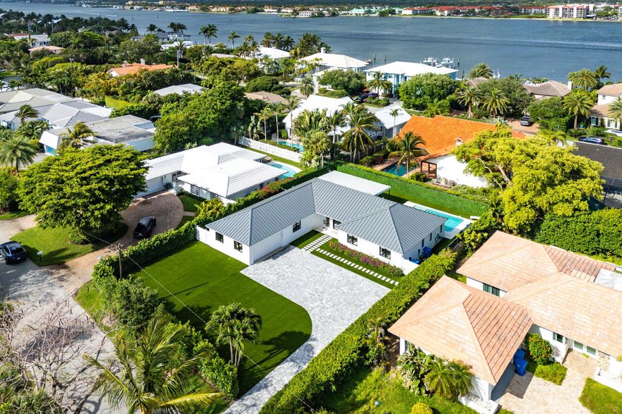 Stunning Custom Coastal Modern on Hypoluxo Island. Welcome to one of South Florida's best-kept secrets—Hypoluxo Island, a charming, exclusive coastal enclave that captures the essence of laid-back luxury living. Nestled just seconds from the beach, this completely renovated one-story residence offers exceptional design, thoughtful upgrades, and a rare combination of elegance and comfort. No expense was spared in crafting this 4-bedroom, 3.5-bath custom home—an uncommon find on the island, where most properties offer fewer bedrooms. Featuring a wide open floor plan, soaring ceilings, and top-of-the-line finishes throughout, this home effortlessly blends Coastal Modern aesthetics with effortless functionality. Enjoy stress-free living with turf landscaping in the backyard, making maintenance a breeze. The sparkling pool area is perfect for entertaining or relaxing in your own private oasis. A two-car garage and barrel tile roof complete the thoughtful design. Whether you're walking to the beach, exploring the scenic island, or relaxing by your pool, this home offers a lifestyle of tranquility and convenience. Just 23 minutes to Palm Beach, 15 minutes to Atlantic Avenue in Delray Beach, and with easy access to major airports, this location provides the perfect balance of seclusion and accessibility.