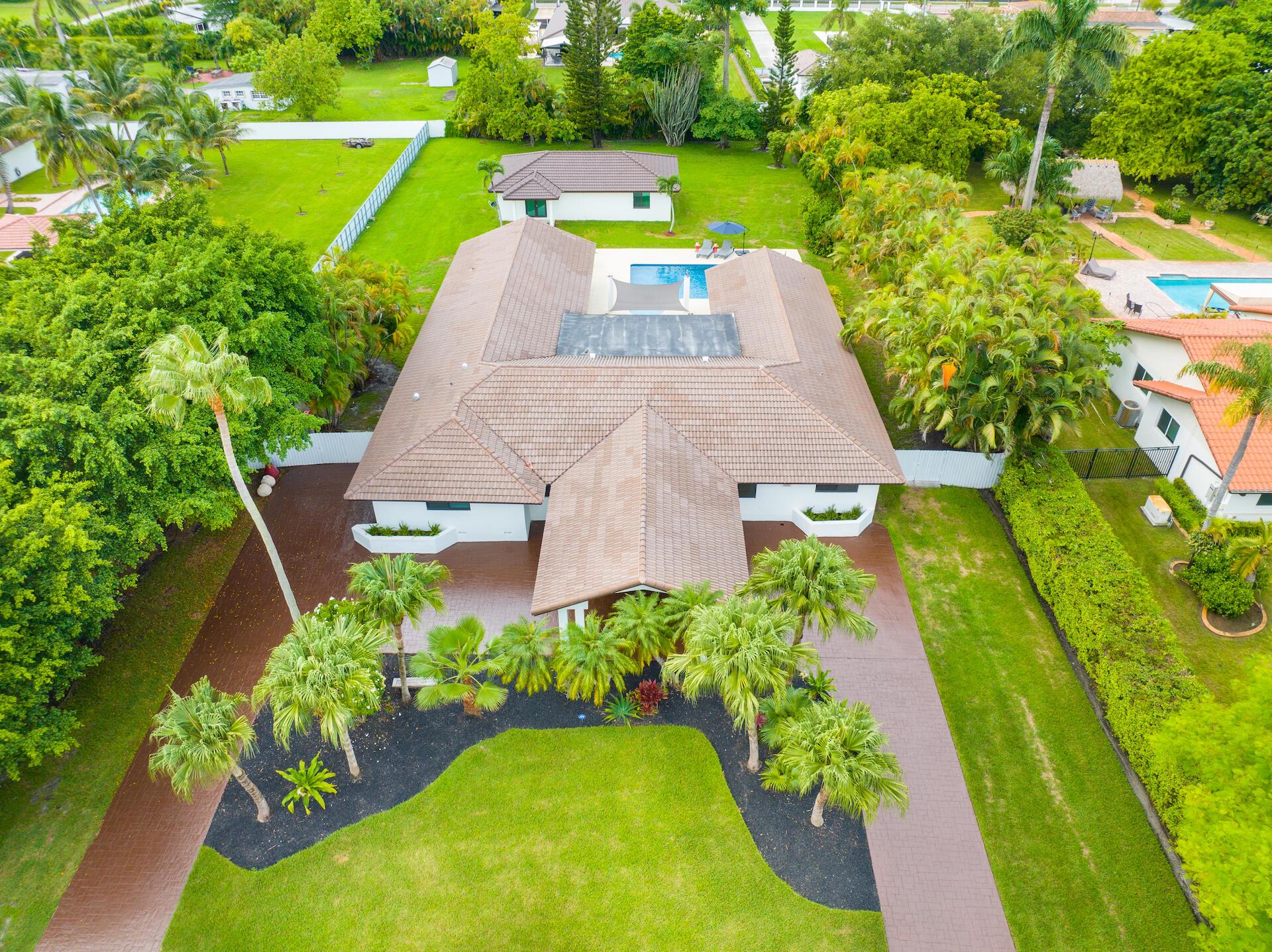 Discover the perfect blend of modern elegance and family-friendly design in this meticulously renovated estate. Set on a sprawling one-acre lot, this exceptional property features a brand-new roof and full impact windows and doors on both the main residence and the guest house--offering style, safety, and peace of mind.Ideally located within walking distance of top-rated private schools, including Belen Jesuit and Conchita Espinosa Academy, this home is thoughtfully designed for both daily living and exceptional entertaining.Step into the main residence, where you'll find 5 spacious bedrooms and 4.5 beautifully updated bathrooms. The luxurious primary suite is a true sanctuary, complete with a custom walk-in closet and a spa-inspired bathroom that exudes tranquility.