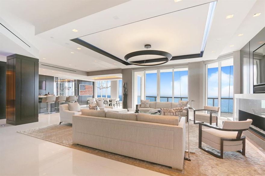 Breathtaking direct ocean views from this beautifully appointed, spacious penthouse apartment.  The direct ocean views are viewed from the living room, dining room great room and kitchen. The water views expand to include the Intracoastal to the north and west. The penthouse lives like an oasis with a pallet of white and light silver gray and custom features adorning the entire unit including marble and walnut finishes plus custom lighting. The expansive north balcony features a spa and fountains as well as sitting areas and a full outdoor kitchen and bar.  The interior features include Creston and Lutron system, built-in speakers, refrigerator drawers, warming drawers, built-in Miele coffee-expresso maker, ice maker in the bar and security cameras.