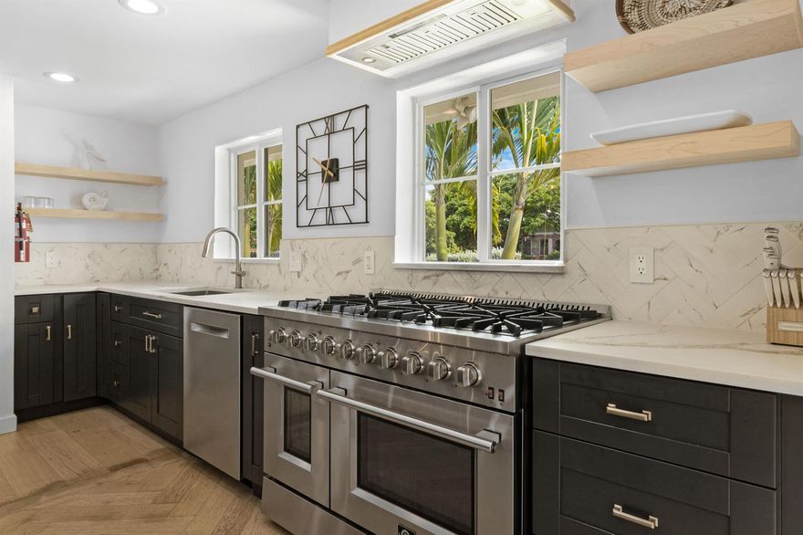 Live the Lighthouse Point lifestyle just steps from Cap's Place and Frank McDonough Park! This fully SOLAR-powered (owned solar) 4 bed, 4 FULL bath home blends cutting-edge technology with elevated coastal comfort, boasting over 2,600 sqft of living space, ideal for entertaining. The chef's kitchen stuns with a leathered honed quartz island, 8-burner GAS RANGE (120-gallon tank), oversized 66'' built-in refrigerator and freezer, MIELE BUILT-in COFFEE system, and wine fridge. Bright, open-concept living areas feature white oak engineered hardwood flooring and a sleek ventless bioethanol fireplace. Dual A/Cs (2024 & 2011), two tankless water heaters (2021), IMPACT WINDOWS, updated electrical panels and PVC PLUMBING to ensure peace of mind. Love the furniture too? Furniture can be