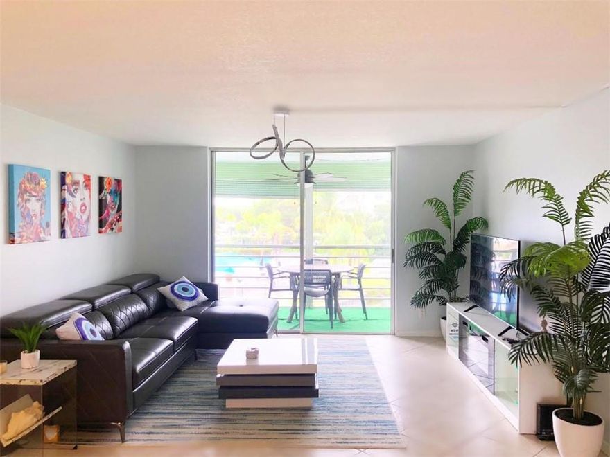 Beautiful, spacious and rare one bedroom one and a half bath, renovated, fully furnished with quality, modern furniture & lux lighting. Balcony overlooking lake. Solid wood cabinets w/ custom hardware, clean appliances & new water heater & garbage disposal recently installed. All tile flooring. Very bright facing South. Master has 2 walk-in closets & small modern desk space including all in one PC. Washer/dryer down the hall with private storage room. NO AGE RESTRICTIONS in this Florida style building. Pool, clubhouse, ping pong, recent 40 yr inspection & exterior painting completed. About 1 mile to the ocean on wide trails for walking, skating or bicycling. Close to highways, airport, seaport, grocers, dining, casino, etc. No special assessments. Low maintenance. OK to lease after 1 year. Tv stand has built in led lighting that can change with remote and also a working fireplace that offers heat if preferred or setting for no heat but fire look only.