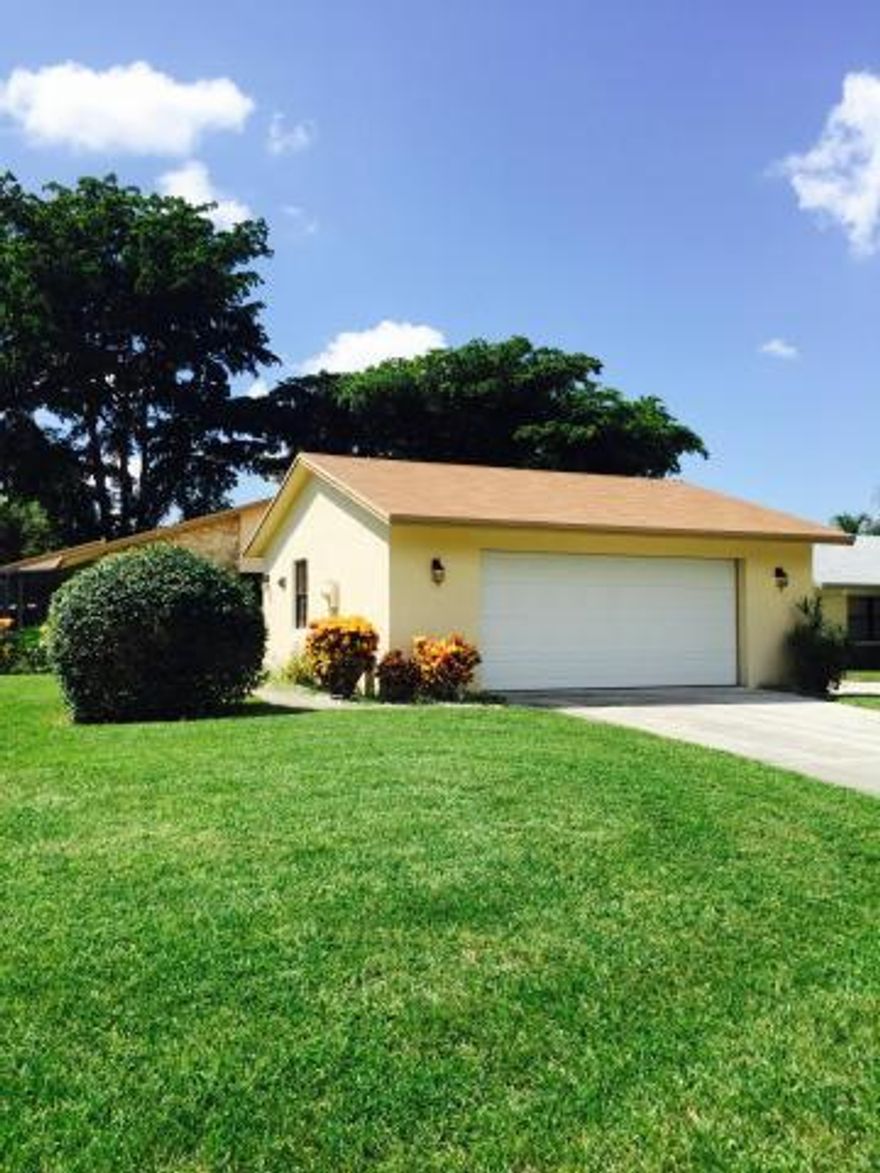 Best landscaped house on the block featuring 2 bedrooms and 2 baths tiled throughout. Just installed brand new kitchen with luxurious granite countertops and modern shaker style wood cabinets (42 inch).ALL NEW STAINLESS STELL APP BEING INSTALLED! Updated baths with granite vanities and Italian tile. Oversized screened patio perfect for relaxing outdoors all year long. 2 car garage with brand new washer/dryer.One of the best adult community's in South Florida. Clubhouse, tennis facility, theatre, 5 satellite pools, and 24/7 manned gate