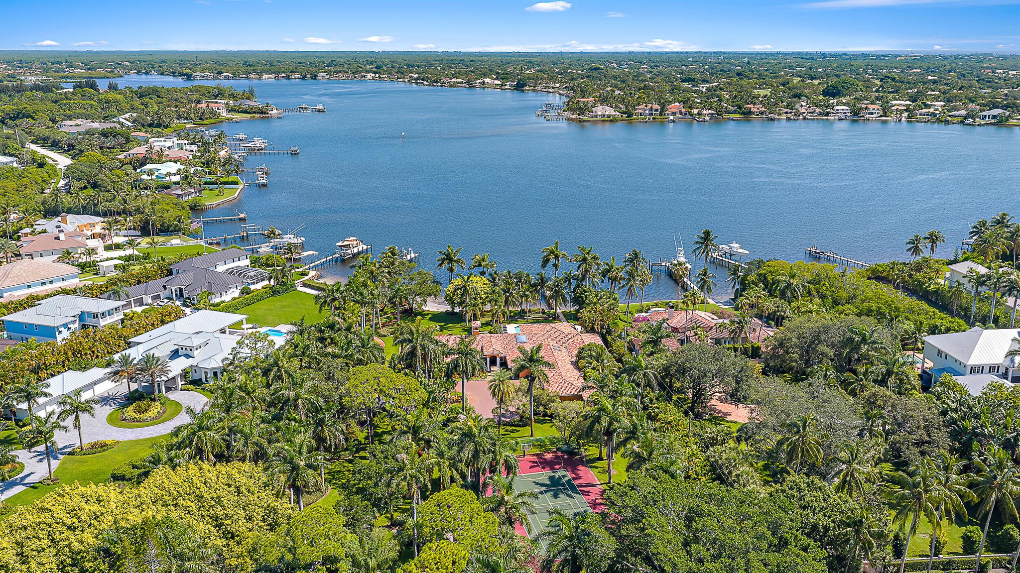 Set on over 2.5 acres with approximately 200 feet of direct riverfront, this is one of the most extraordinary properties ever offered on prestigious Pennock Point. Enjoy panoramic views of the Loxahatchee River from a homesite enveloped in mature, tropical landscaping offering unmatched privacy and a natural, estate-like setting that's increasingly rare in South Florida. Whether you choose to build a legacy residence, explore subdivision opportunities, or move into the existing home, the possibilities are endless. Pennock Point is one of Florida's most desirable waterfront enclaves, known for its expansive lots, peaceful riverfront lifestyle, and close proximity to everything Jupiter has to offer including some of the finest golf courses in the country.