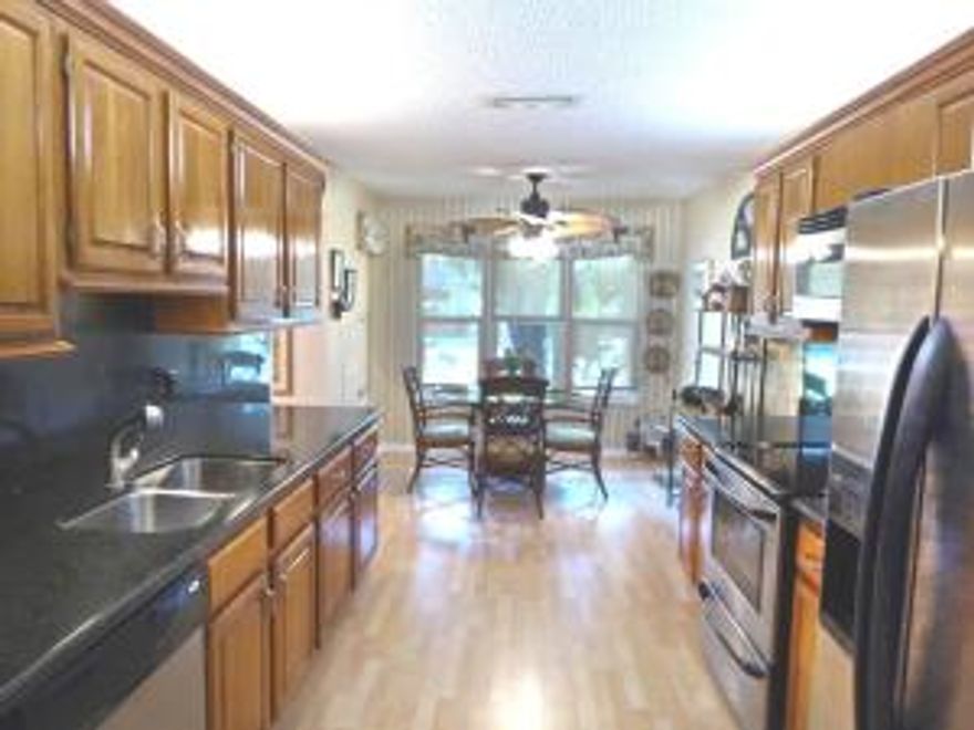 METICULOUSLY  MAINTAINED & UPDATED  2STORY TOWNHOME W/GARAGE LOCATED IN THE HEART OF WELLINGTON IN QUIET CUL-DE-SAC, BOASTING HURRICANE WINDOWS AS WELL AS ACCORDION HURRICANE SHUTTERS. TASTEFULLY REMODELED 21FT KITCHEN W/WOOD CABINETRY, GRANITE, STAINLESS APPLIANCES (MICROWAVE ALSO A CONVECTION OVEN) & BKFST AREA. OVER 2,000 SQ FT OF LIVING INCLUDES FORMAL DINING, LIVING & FAMILY ROOMS. OUTDOORS OFFERS FRONT SCRD PATIO, REAR COVERED SCRD PATIO W/ENCLOSURE AFFORDING YEAR-ROUND ENJOYMENT & SLIDER LEADING TO RAISED WOOD PATIO, & FENCED PRIVACY GARDEN. 2ND FLOOR HOUSES LOVELY MASTER SUITE W/UPDATED BATH & SEPARATE COMMODE & SHOWER RM & WALK-IN CLOSET. TWO ADDITIONAL BDRMS W/ADJACENT DESIGNER BATH COMPLETE THE PICTURE. HOA PROVIDES COMMUNITY POOL, LAWN MAINTENANCE, CABLE & EXTERIOR PAINTING.