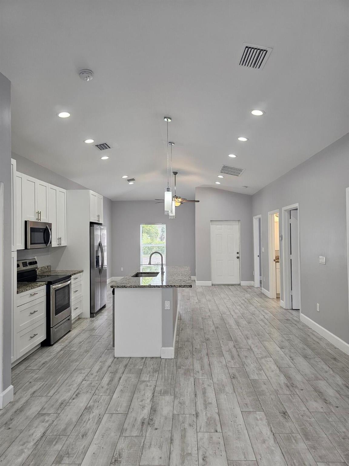 Experience luxury living in this stunning 3-bedroom, 2.5-bathroom rental, equipped with all modern conveniences. The updated kitchen features stainless steel appliances, granite countertops, and a kitchen island, all designed with a modern and sleek contemporary aesthetic. All windows have blinds for added privacy, and impact glass windows ensure additional security. Relax in the fenced backyard with a paver patio or unwind in one of the three spacious bedrooms. This stylish home includes 2 parking spaces. Don't miss this opportunity.