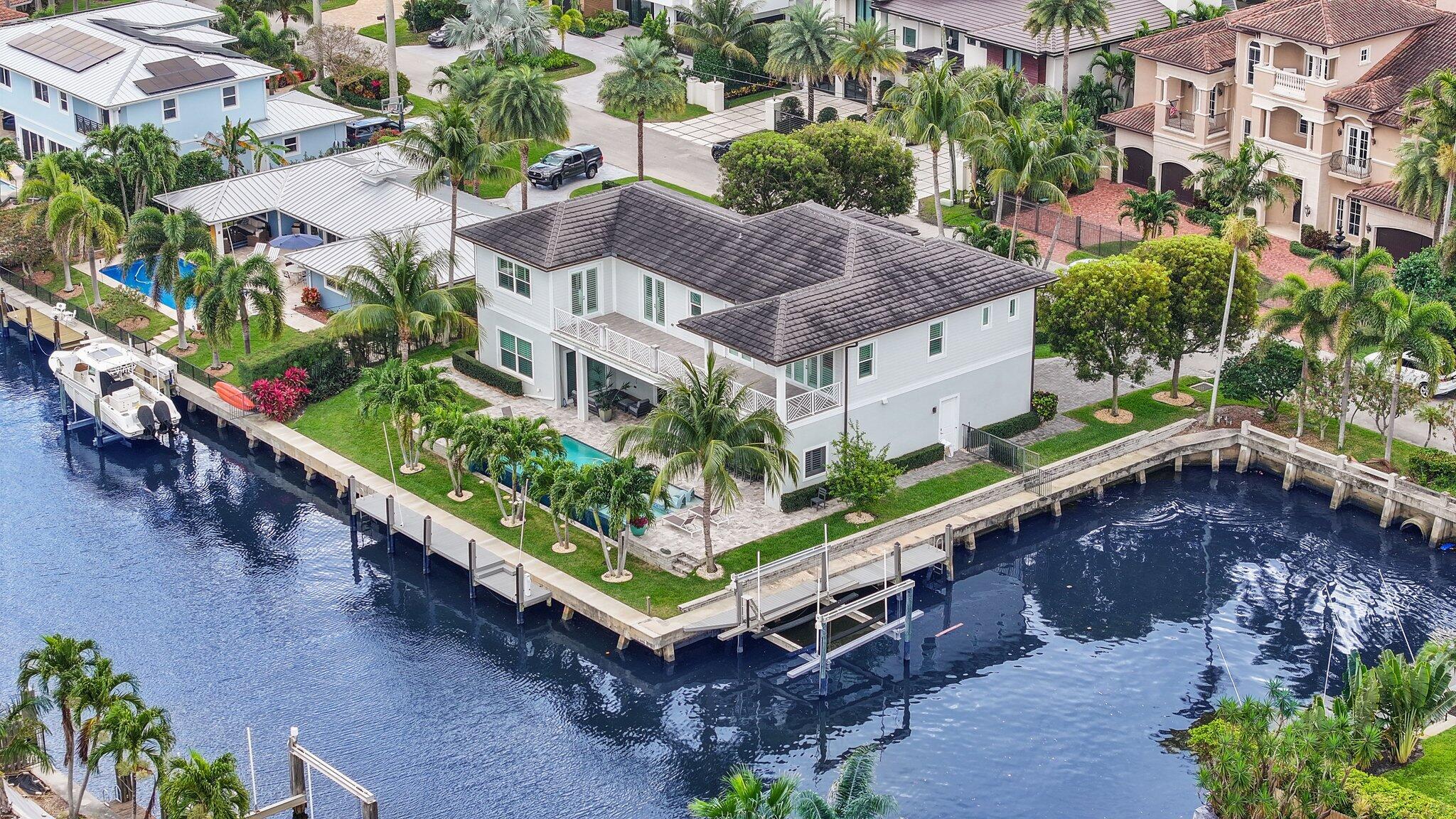 Welcome to 917 Tropic Blvd, a true boater's dream home located in the prestigious waterfront community of Tropic Isle in Delray Beach, Florida. This luxury estate offers 200 feet of deep-water frontage, providing ample space to dock your yacht, boat, and water toys--ideal for avid boaters and waterfront lifestyle enthusiasts.Built in 2018 with exceptional craftsmanship, this 5-bedroom, 5-bathroom home is designed for elegant entertaining and relaxed Florida living. The open-concept floor plan features a spacious living area that seamlessly connects to a gourmet kitchen equipped with Thermador appliances, a large quartz island, premium fixtures, and panoramic water views.The first floor includes a private guest suite, a dedicated home office, and two separate