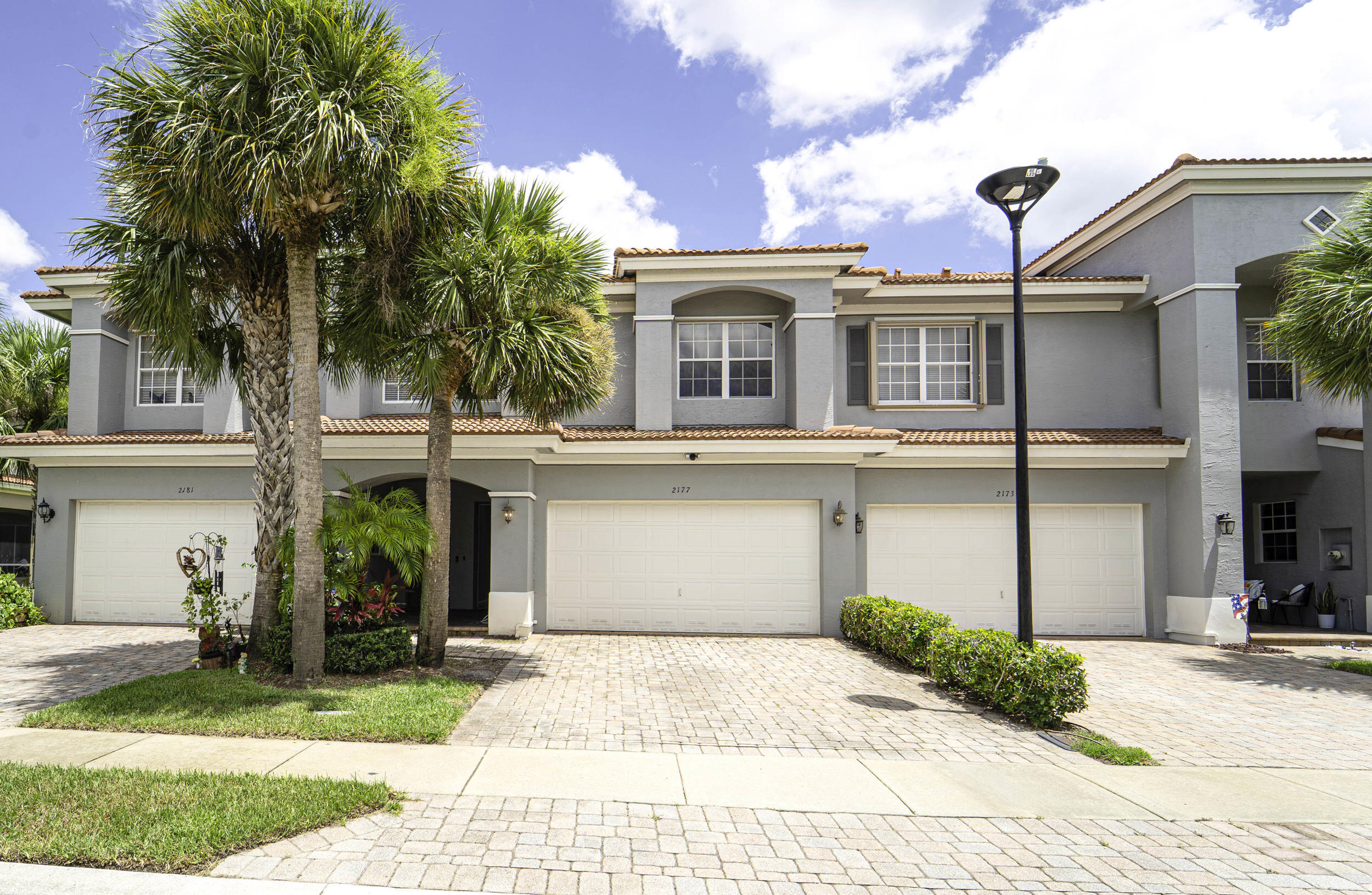 Step into this charming and meticulously maintained townhouse nestled in the highly sought-after gated community of Newport Isles. Featuring 3 spacious bedrooms, 2.5 bathrooms, and an inviting open-concept floor plan, this home is designed for both comfort and effortless entertaining. Enjoy the perfect blend of tile and plush carpet flooring, along with a bright, airy living and dining area that flows seamlessly to your screened-in lanai - the ideal spot to unwind and take in tranquil lake views. Newport Isles offers resort-style living with incredible amenities right at your doorstep: two sparkling pools, a beautiful clubhouse, fully equipped fitness center, tennis courts, playgrounds, and scenic walking paths. Just minutes from the heart of Tradition, you'll love being close to