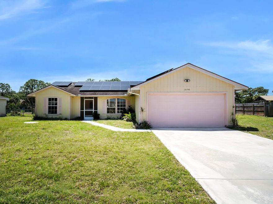 Opportunity awaits in this 3-bedroom, 2-bath, 2-car garage home located in a convenient Port Saint Lucie location! Built in 1992, this property is a true handyman special—perfect for investors or buyers looking to renovate and make it their own. The home features A BRAND NEW A/C UNIT, tall ceilings that enhance the sense of space, a dedicated laundry room for added convenience, and an in-ground heated pool ideal for year-round enjoyment. Solar panels are already in place, offering potential energy savings. Situated on a canal, the property provides added privacy and a peaceful backyard setting. With solid bones and desirable features, this home is full of potential for the right buyer willing to bring their vision to life.