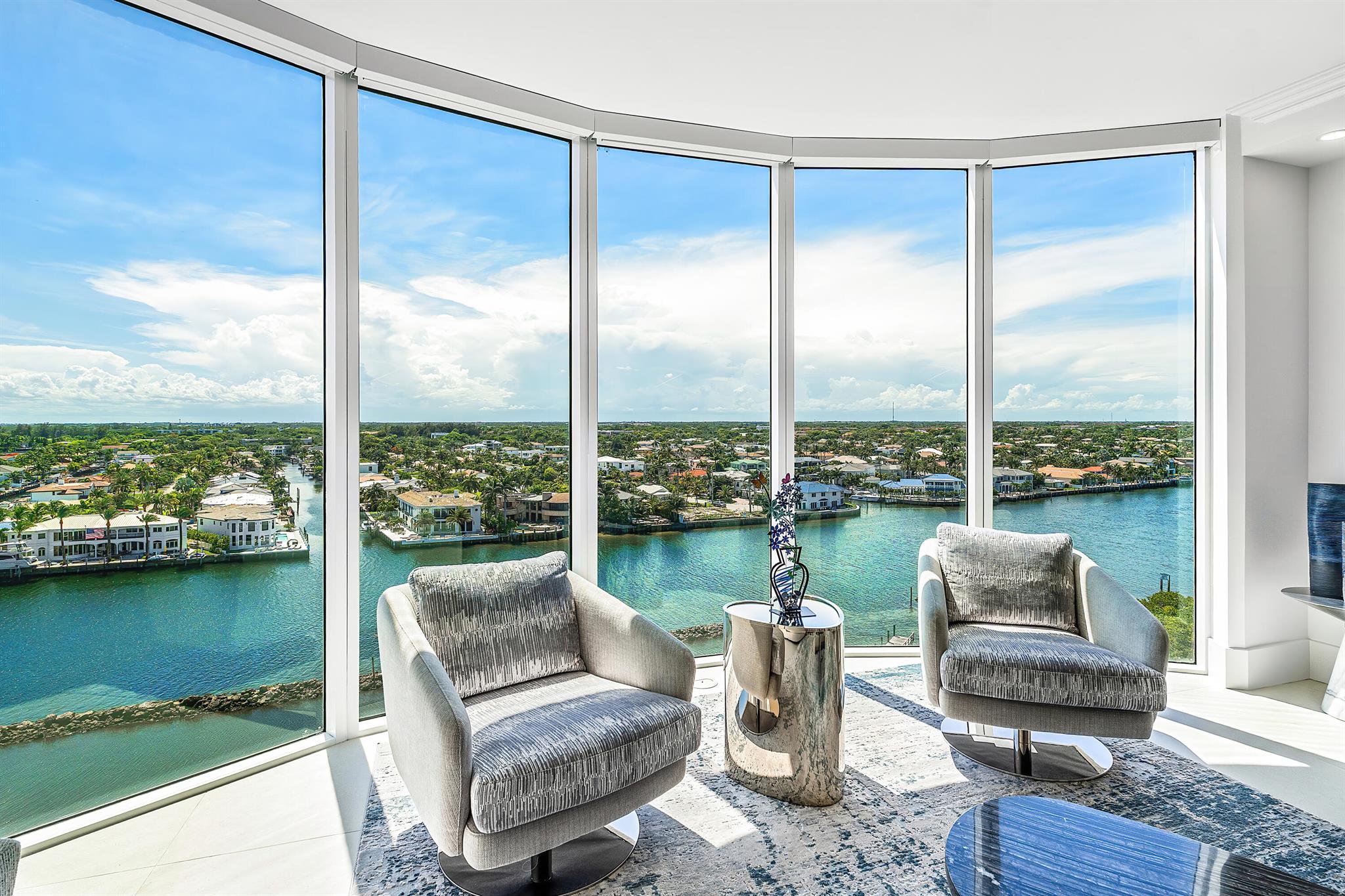 Perched high above a uniquely beautiful stretch of the Intracoastal, this rarely available corner residence captures sweeping views of the water, lush preserve, sparkling city lights, and distant ocean. Completely renovated just three years ago, the home blends modern elegance with timeless coastal design.A private elevator opens into your foyer, revealing an open layout with soaring ceilings and oversized porcelain tile flooring. The chef's kitchen features Sub-Zero and Wolf appliances, quartz countertops, custom cabinetry, and a full-size wine fridge. Two expansive balconies invite seamless indoor-outdoor living.Wake up to breathtaking panoramic views from the primary suite, which offers direct balcony access and a serene vantage point over the Intracoastal and nature