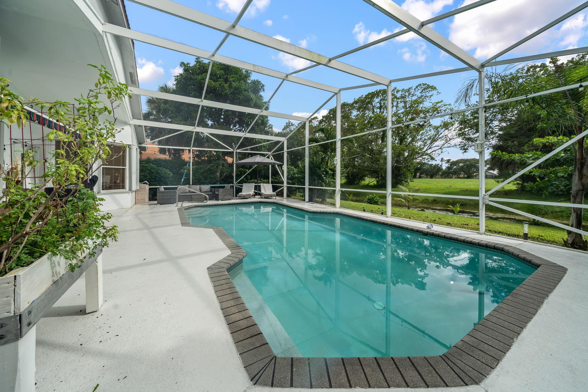 Discover the ultimate Wellington lifestyle with this beautifully remodeled home situated in the heart of Wellington. Offering modern luxury with an inviting open-concept design, upgraded finishes throughout, and spacious living areas that blend comfort with style. Step outside to your private backyard oasis, where a serene waterfront view and sparkling pool create the perfect setting to unwind, entertain, or enjoy sunny Florida days. Located just steps away from a private community park, you'll love the balance of peaceful surroundings & easy access to all that Wellington has to offer. Experience the perfect blend of comfort, privacy, and an unbeatable location--schedule your private tour today!