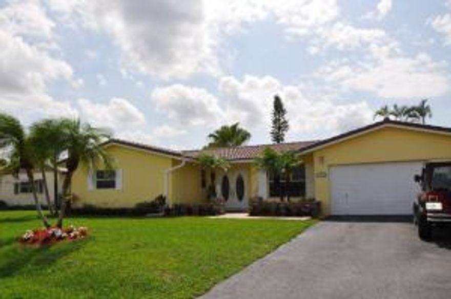 Wonderful Coral Springs 3 bedroom, 2 bathroom, 2 car garage, pool home  for  under $300,000. This beautiful home is situated on one of the largest canal lots in the neighborhood. Many upgrades that have been completed are: both bathrooms have been renovated, real wood floors in sunken living room, large floor moldings,  pool paver deck and diamond brite redone 3 years ago, screen patio retiled and screen enclosure redone. Home also features tile floors in living areas, carpet in bedrooms, a retractable awning in backyard, large laundry room with extra storage, and fully fenced yard. No HOA fees!!! Home is not a REO or Short Sale. Come see today!