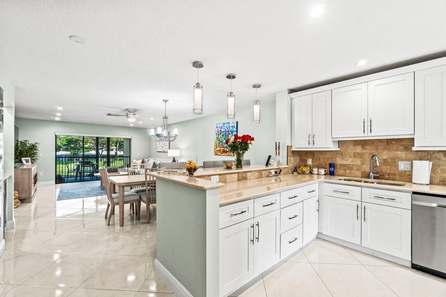 Welcome to this fully remodeled 2BR/2BA residence in Stratford at Hunters Run Country Club, offering an open-concept layout with sleek porcelain tile flooring throughout. The contemporary kitchen flows seamlessly to the dining and living areas, ideal for relaxing or entertaining. Retreat to the spacious primary suite with spa-style en-suite bath featuring a seated shower and dual sinks. Guests will enjoy a large secondary bedroom with semi-private bath. Take in stunning water views from the screened terrace. Unit includes 50% ownership of a newer elevator lift for added convenience. Move right in and enjoy Hunters Run's resort-style amenities including golf, tennis, pickleball, pool, fitness center, spa, dining and nonstop social events. Mandatory membership. Experience world-class club living with 54 holes of championship golf, 18 tennis courts, 12 pickleball courts, a resort-style clubhouse and pool, salon & spa, fitness center, and six dining venues. Brand new racquet sports center coming soon!